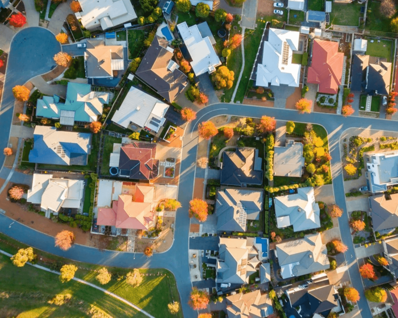 Aerial view of suburban neighborhood with colorful trees