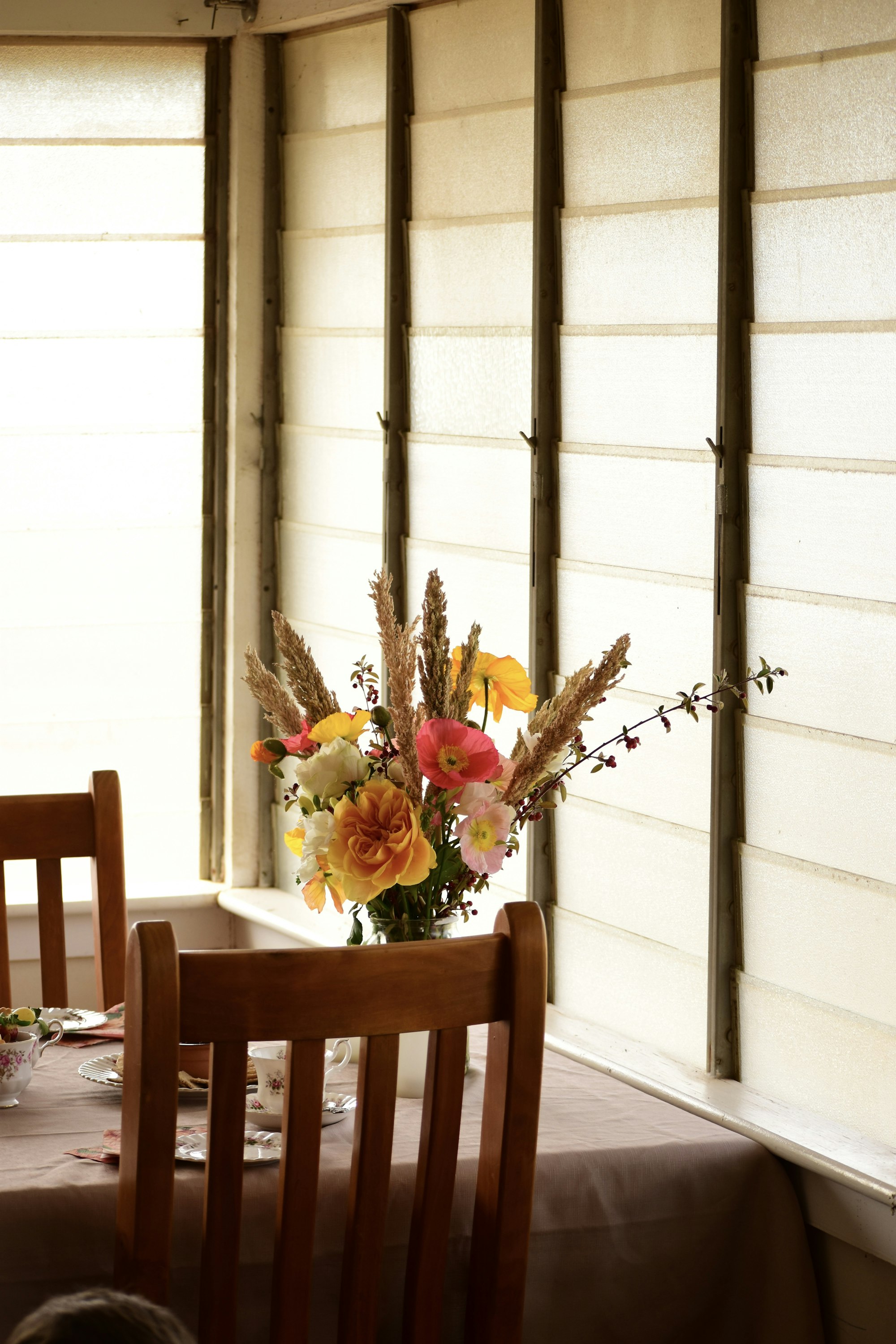 Dried flowers in a vase by a window