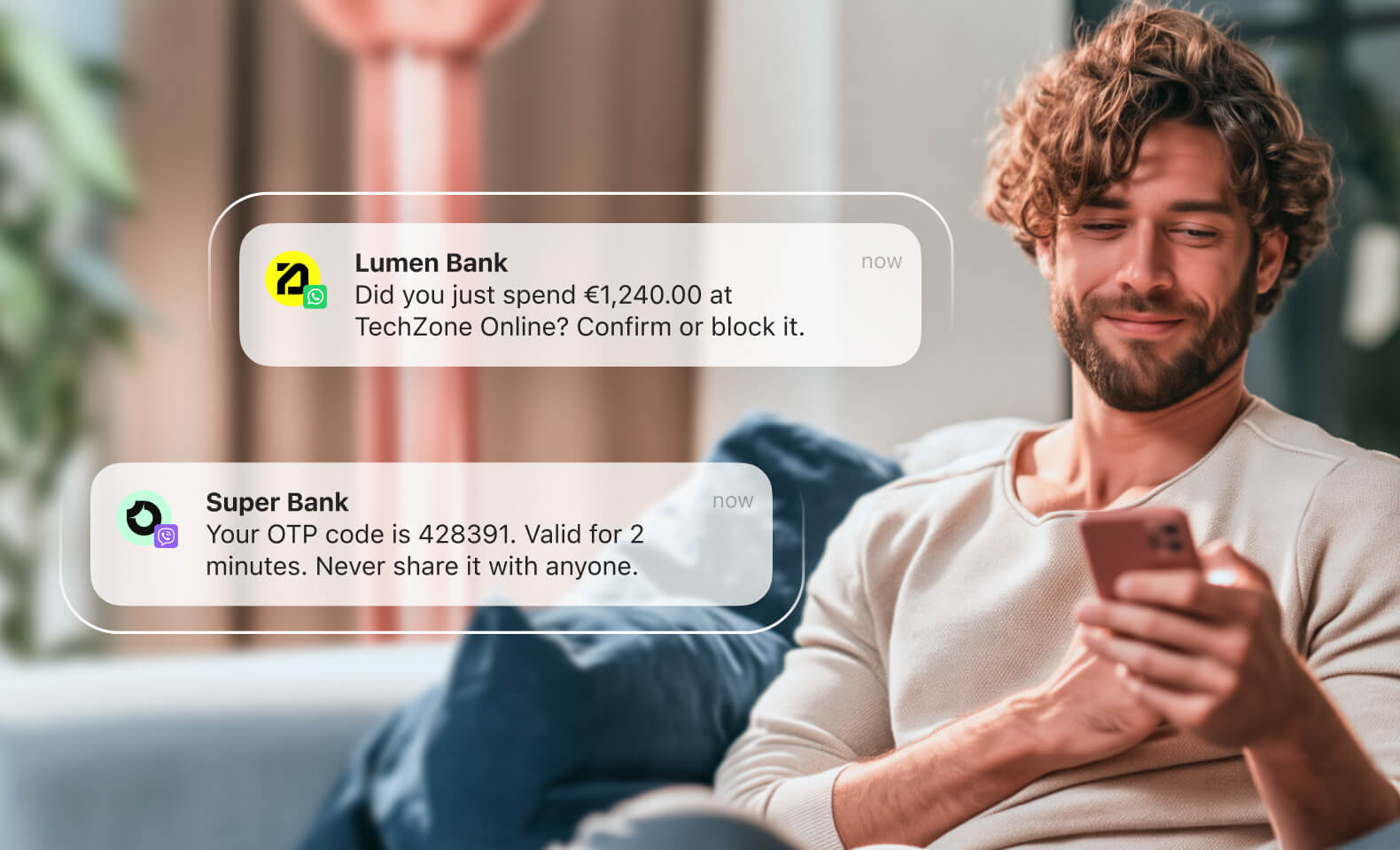 A young man smiles at his smartphone, which displays two transactional messages (OTP code verfication and purchase confirmation), both delivered from his bank via Abelo. (tablet view)
