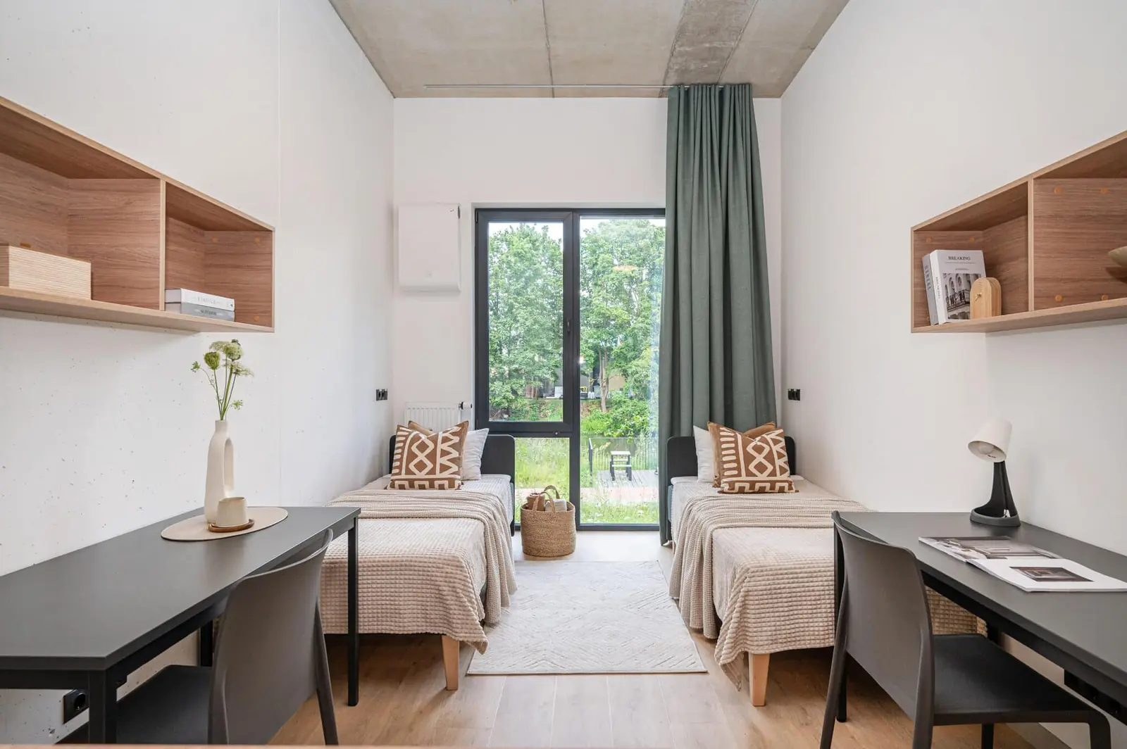 Twin student studio in Riga with two beds, individual desks and shared living space