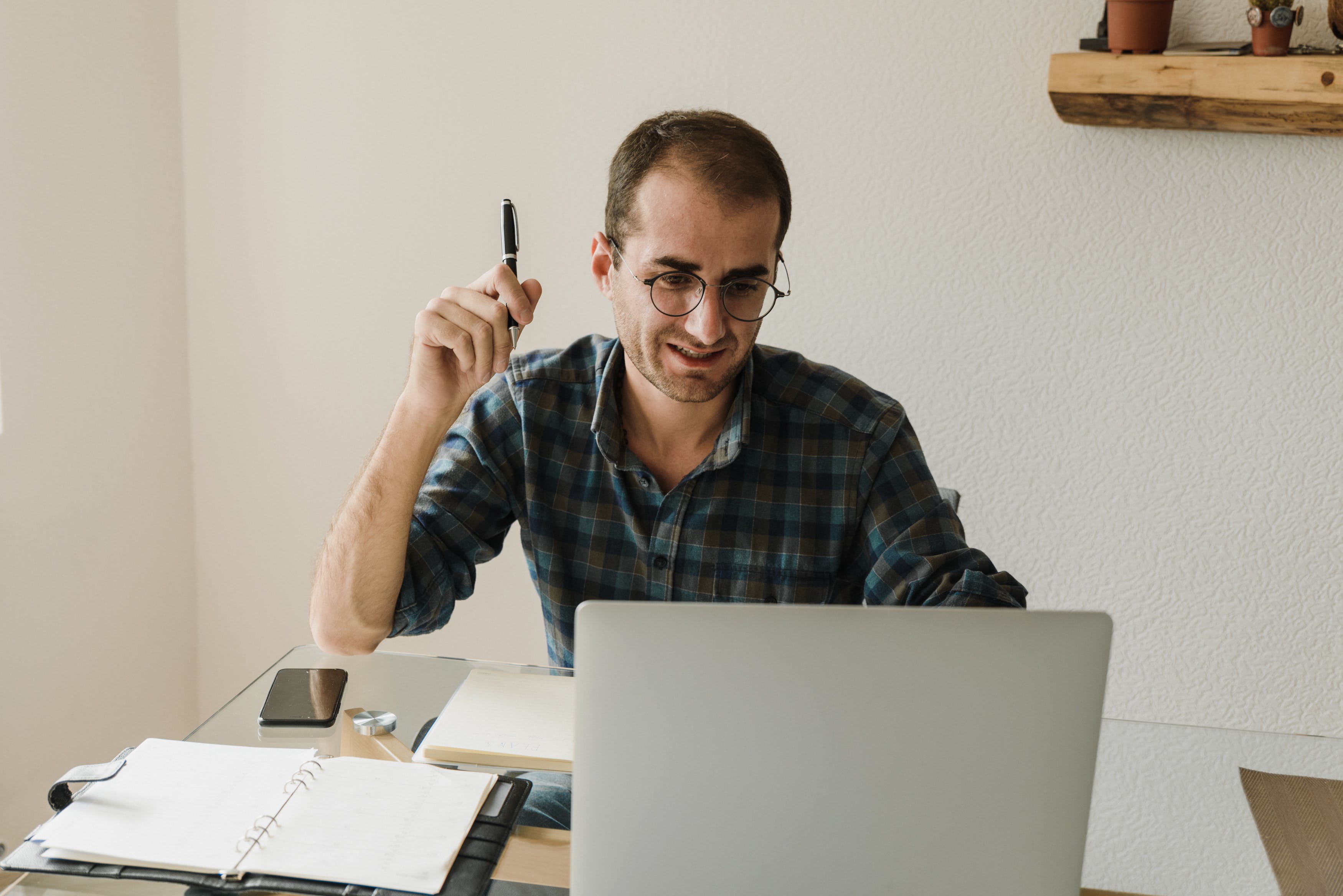 Male working at home writing cold emails using templates