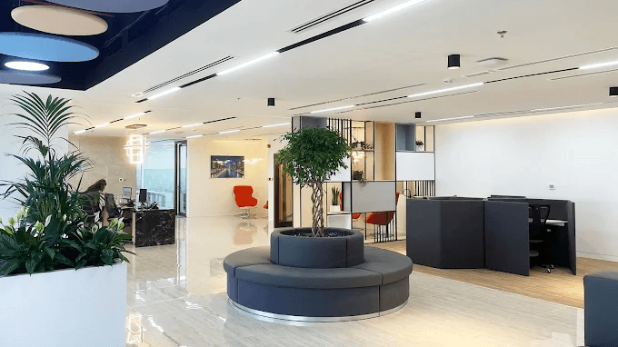 Modern office space with stylish furniture, plants, and comfortable seating, showcasing the design of a managed office by myOffice