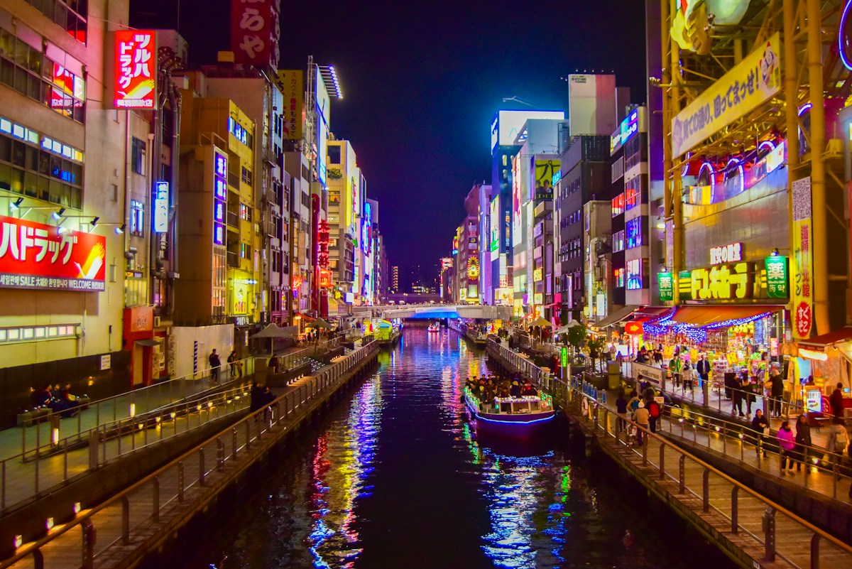 The Dotonbori canal lit up with neon signs at night