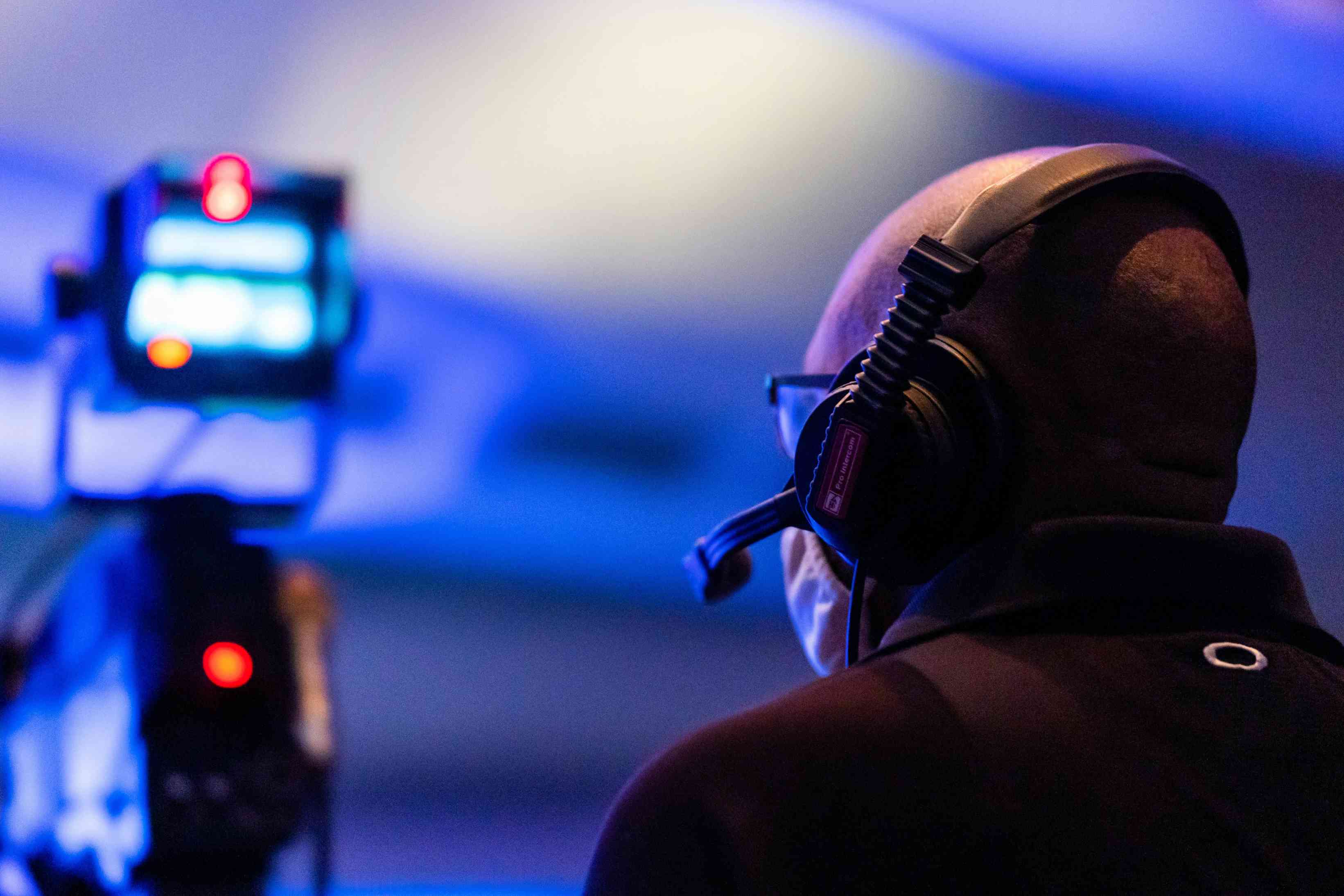 Close-up of a videographer wearing headphones during live event video production