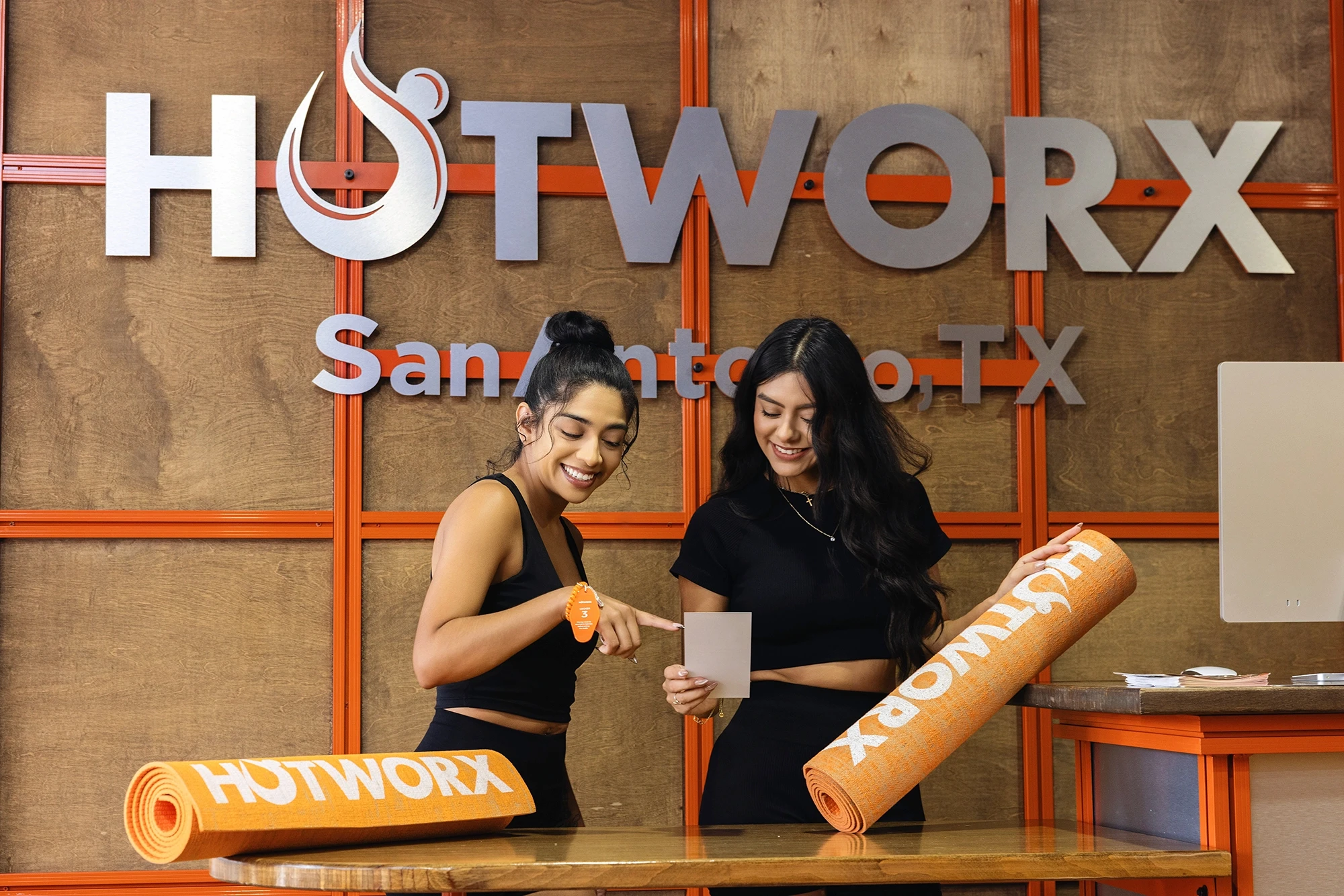 Two women in front of HotWorkx sign