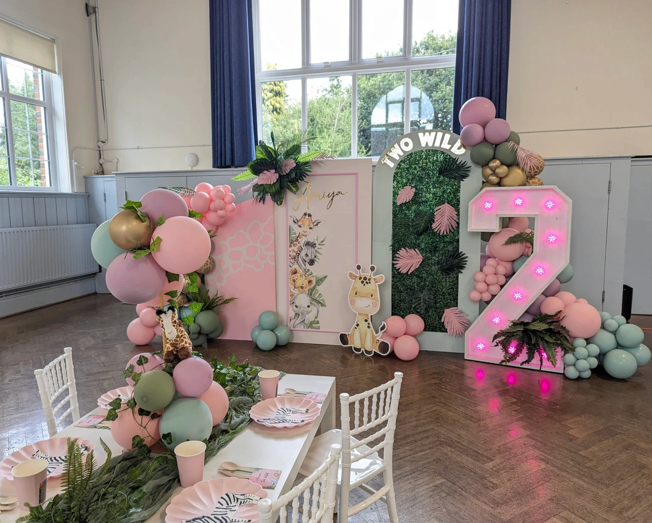 Fully styled event setup, featuring coordinated balloon elements and chic props