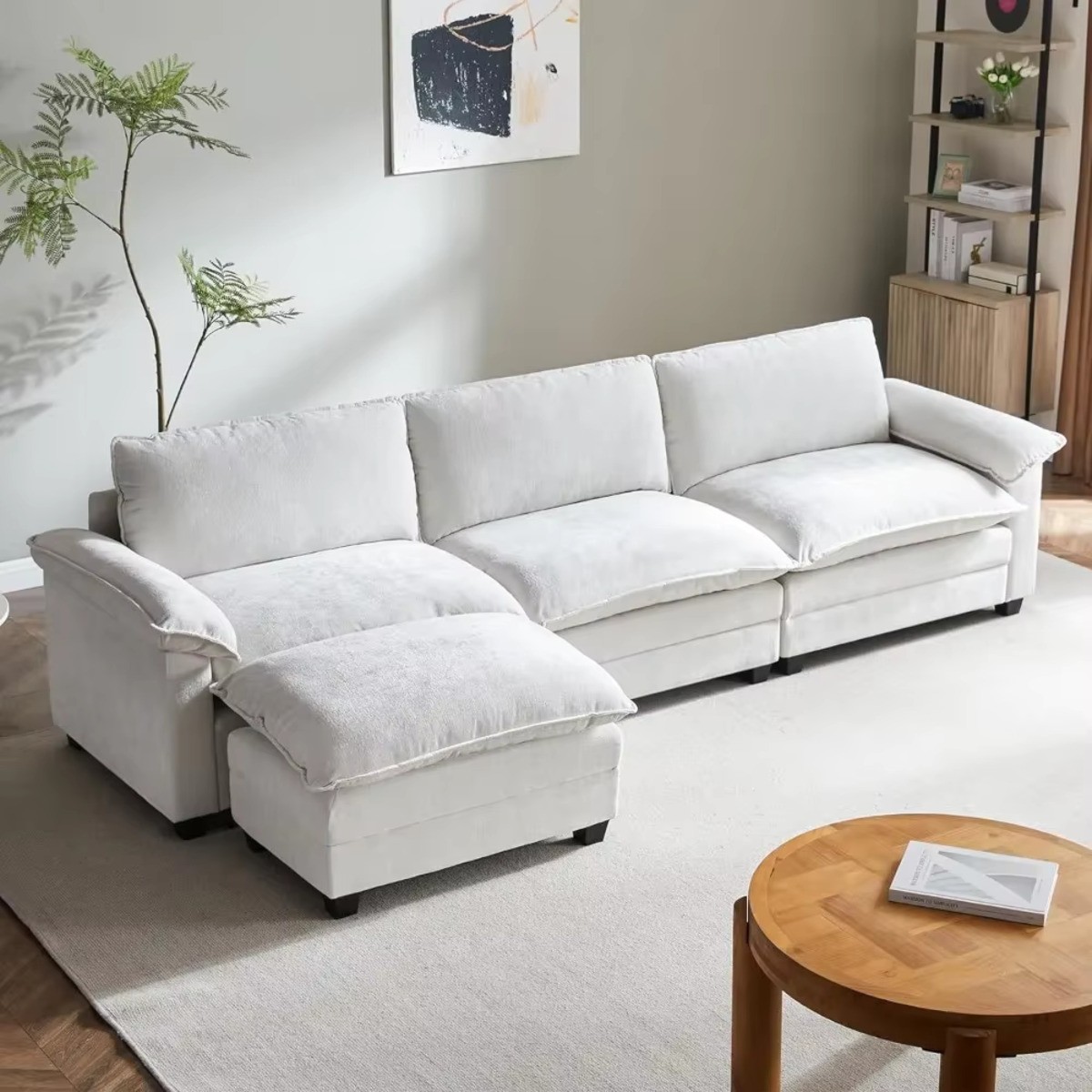 Cloud L-Shaped 3 Seat Sectional with Ottoman in a cozy living room, featuring a wooden table, plant, & modern decor