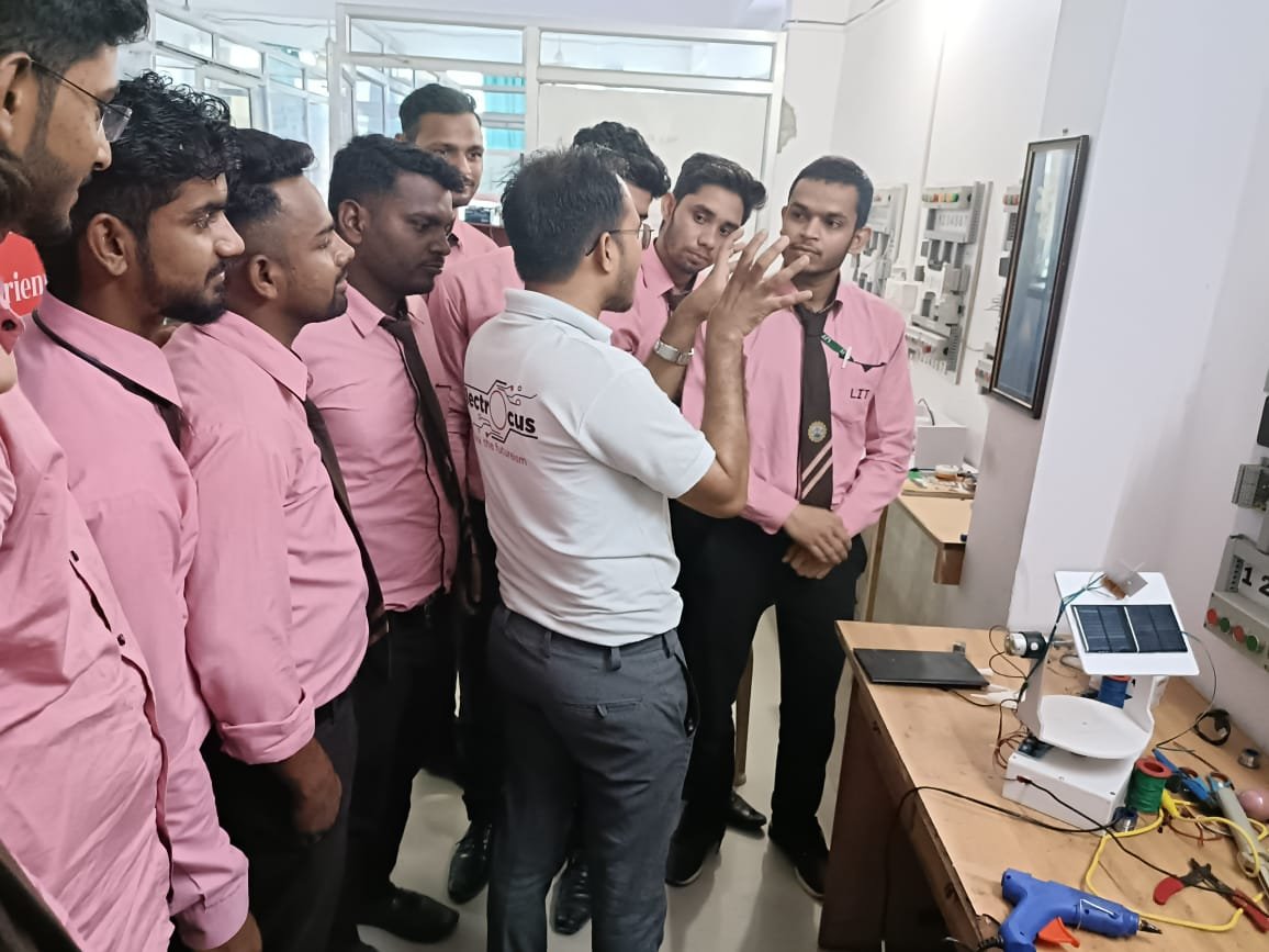 man standing in front of people sitting beside table with laptop computers