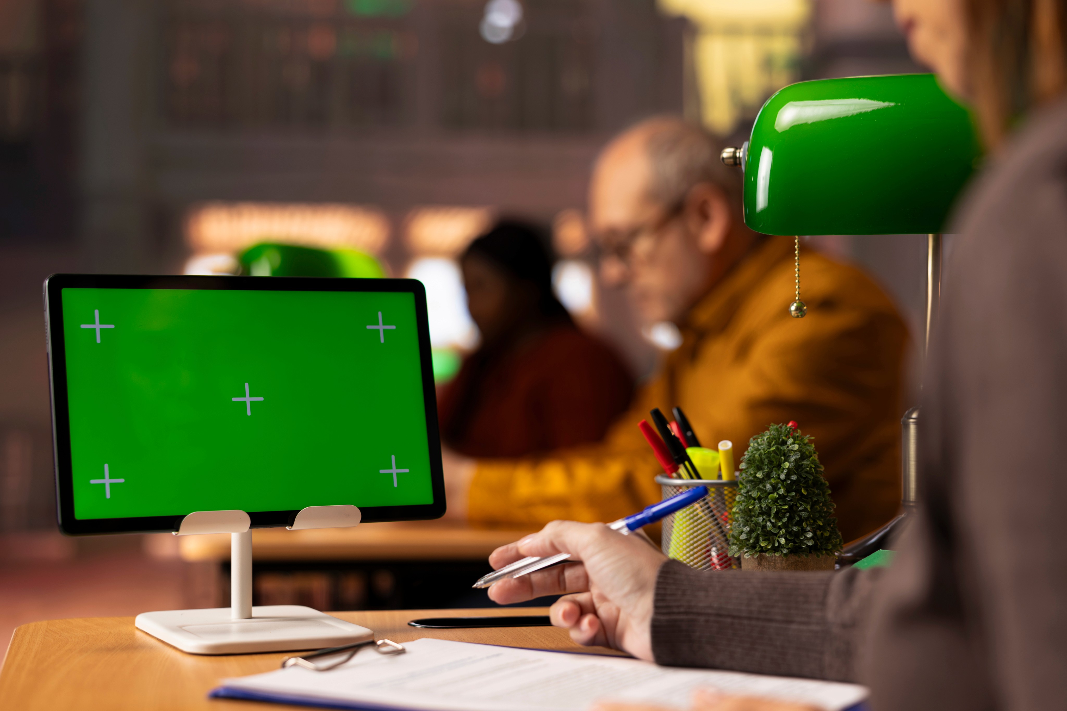 Two men smiling and talking in a modern office.