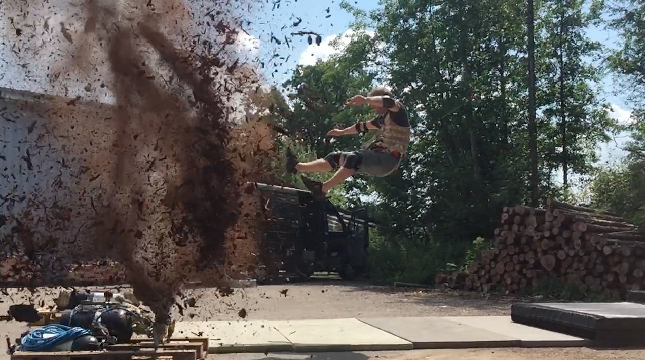 Explosion on set with the stunt performer ripped out of frame at the same moment — that timing runs through separate radio channels for special effects and the stunt team
