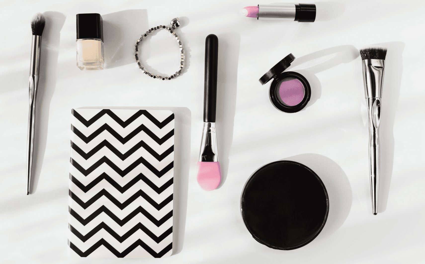cosmetic makeup products and brushes flat lay