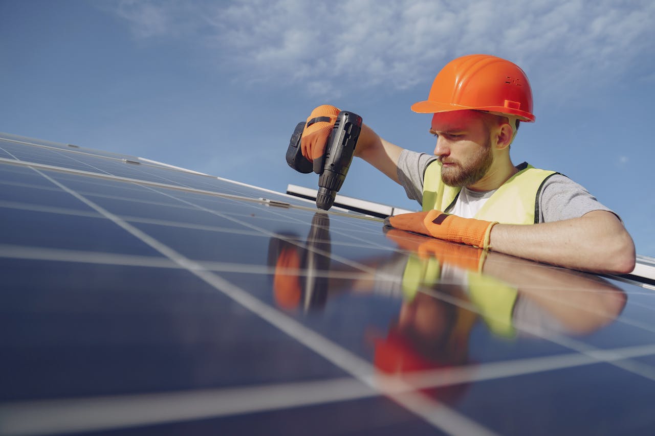 a roofer contractor installing solar panels on the roof