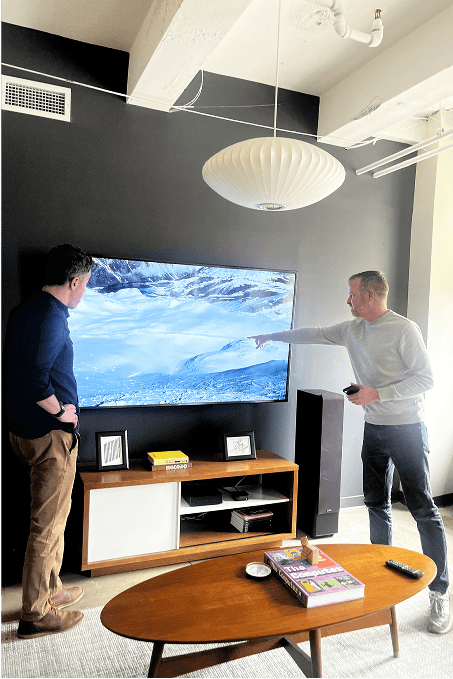 Dan Hughes and Chris Reif pointing at a television