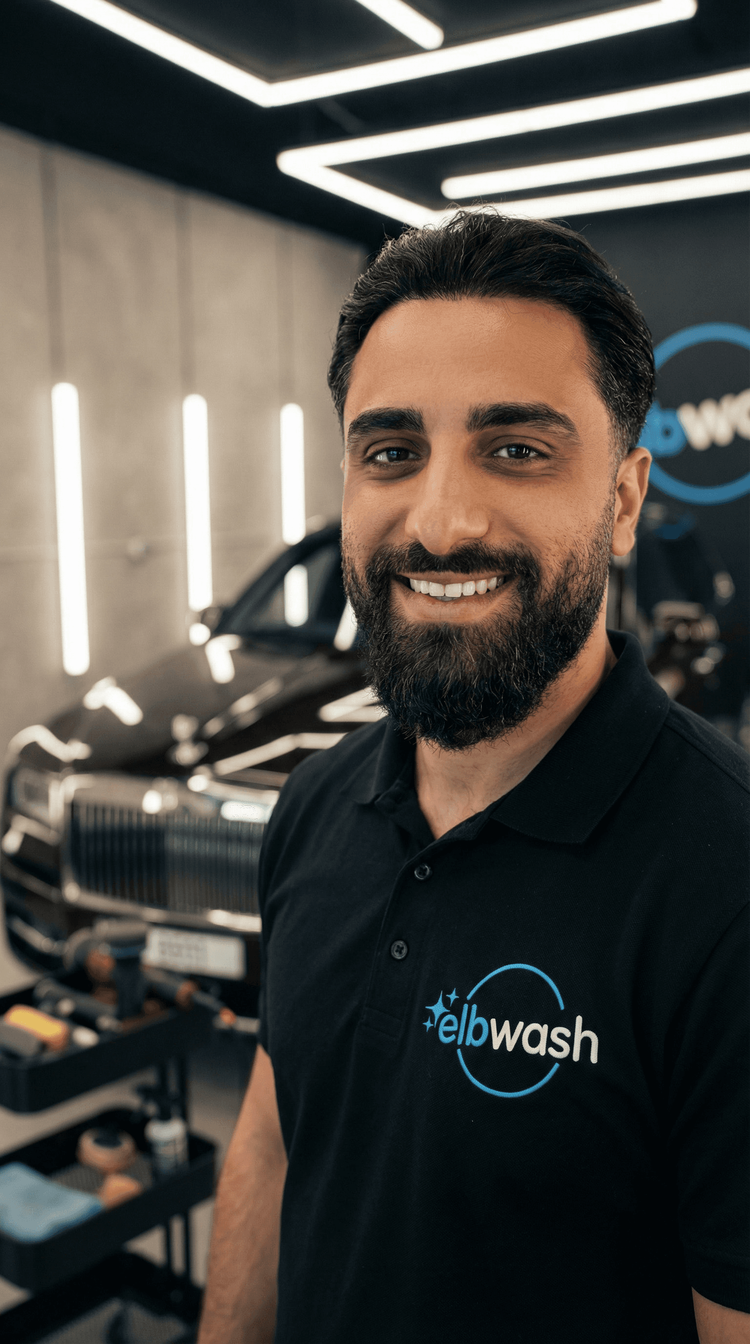 Smiling man in a car.