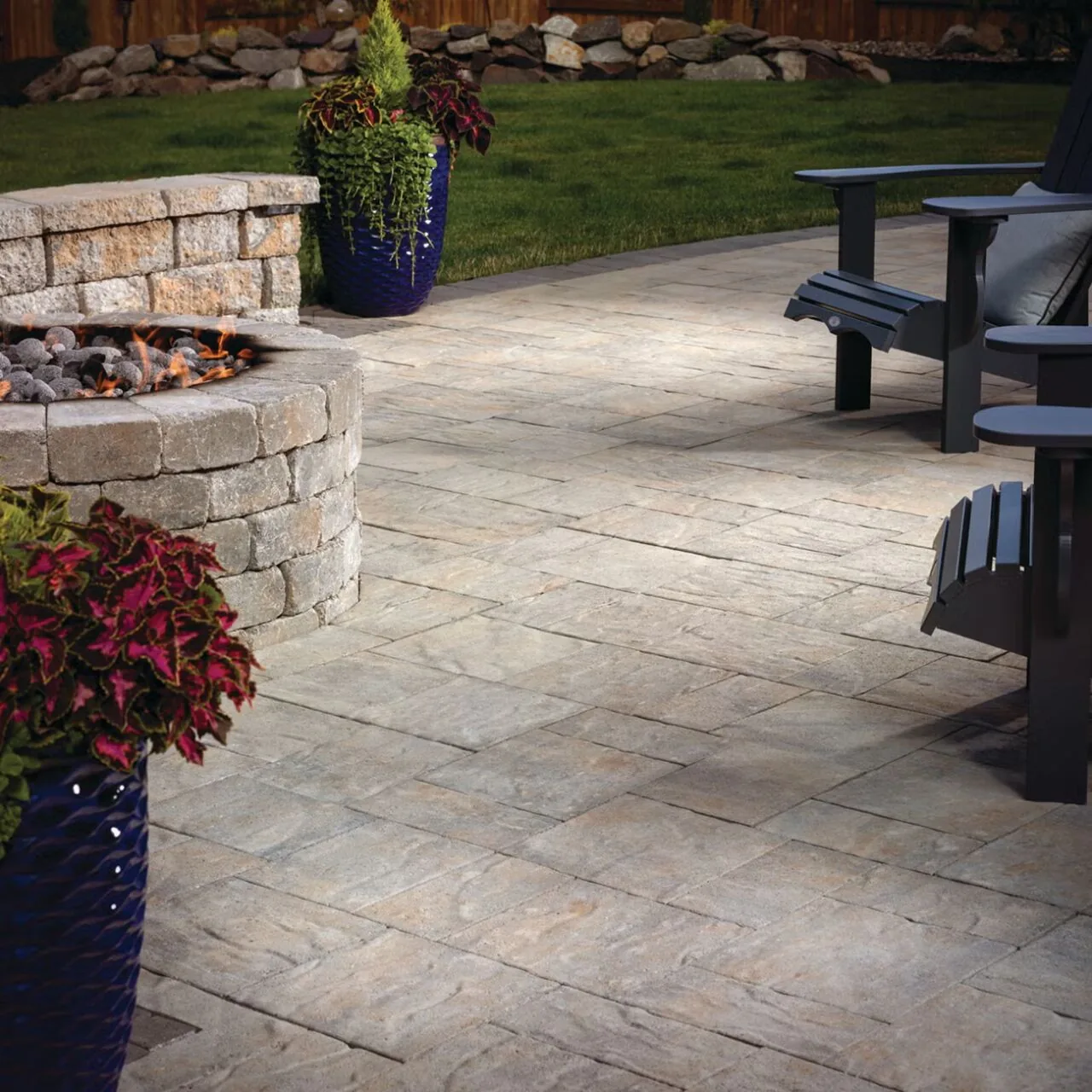 Rectangular paving beside a circular fire pit and outdoor chairs.