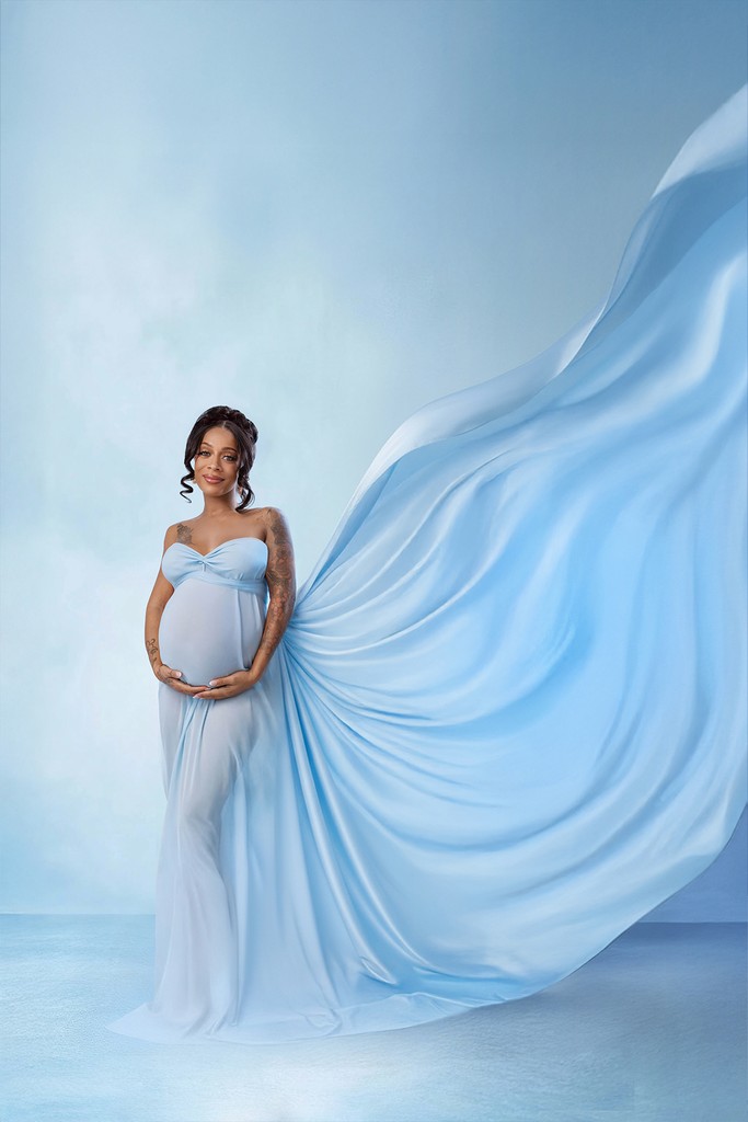 Expecting mom in a flowing fabric maternity gown with soft studio lighting — Bloom N’ Baby Studio, Los Angeles.