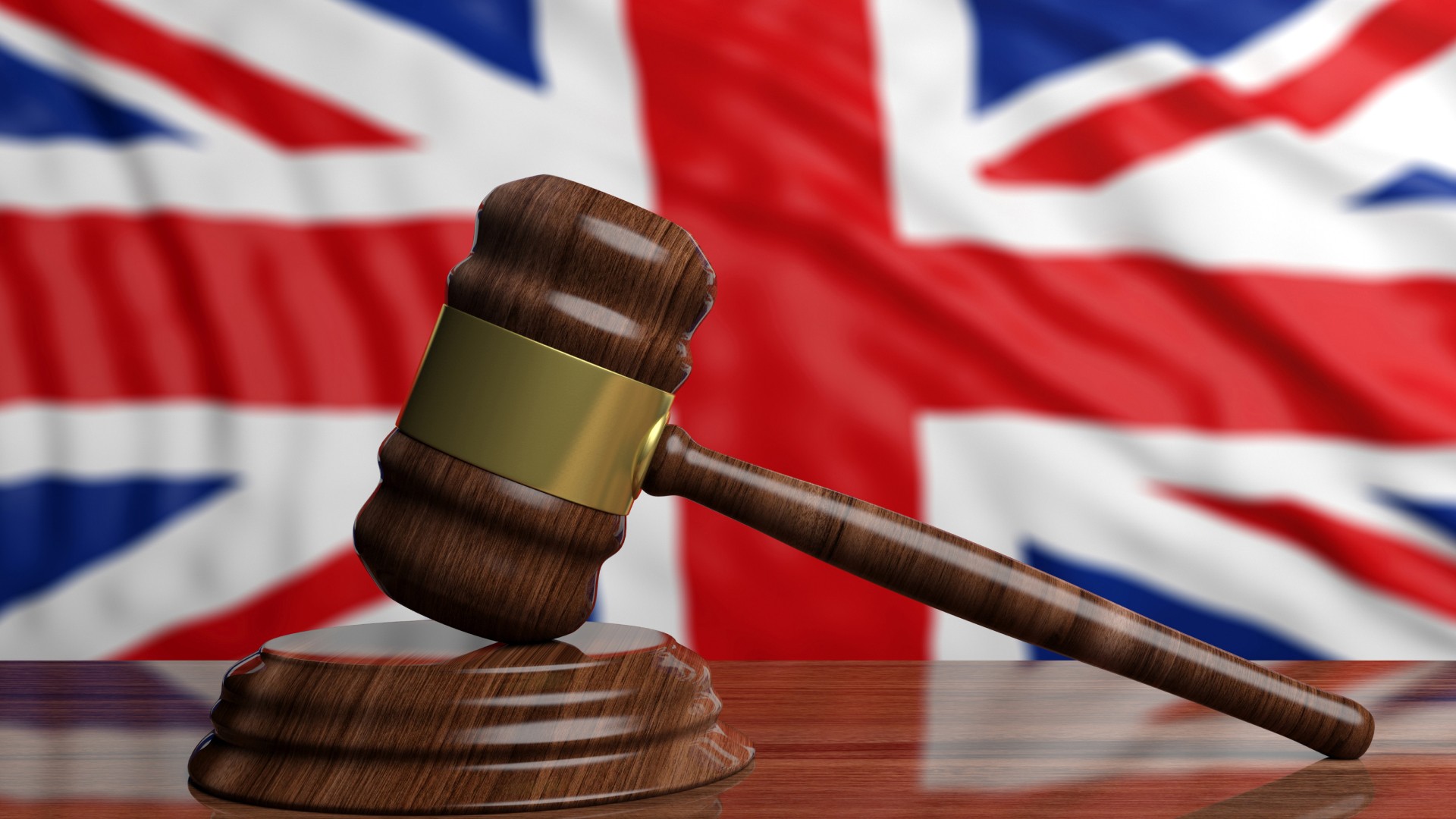 Judge’s gavel in front of the United Kingdom flag, symbolising regulatory changes to the UK sanctions list.