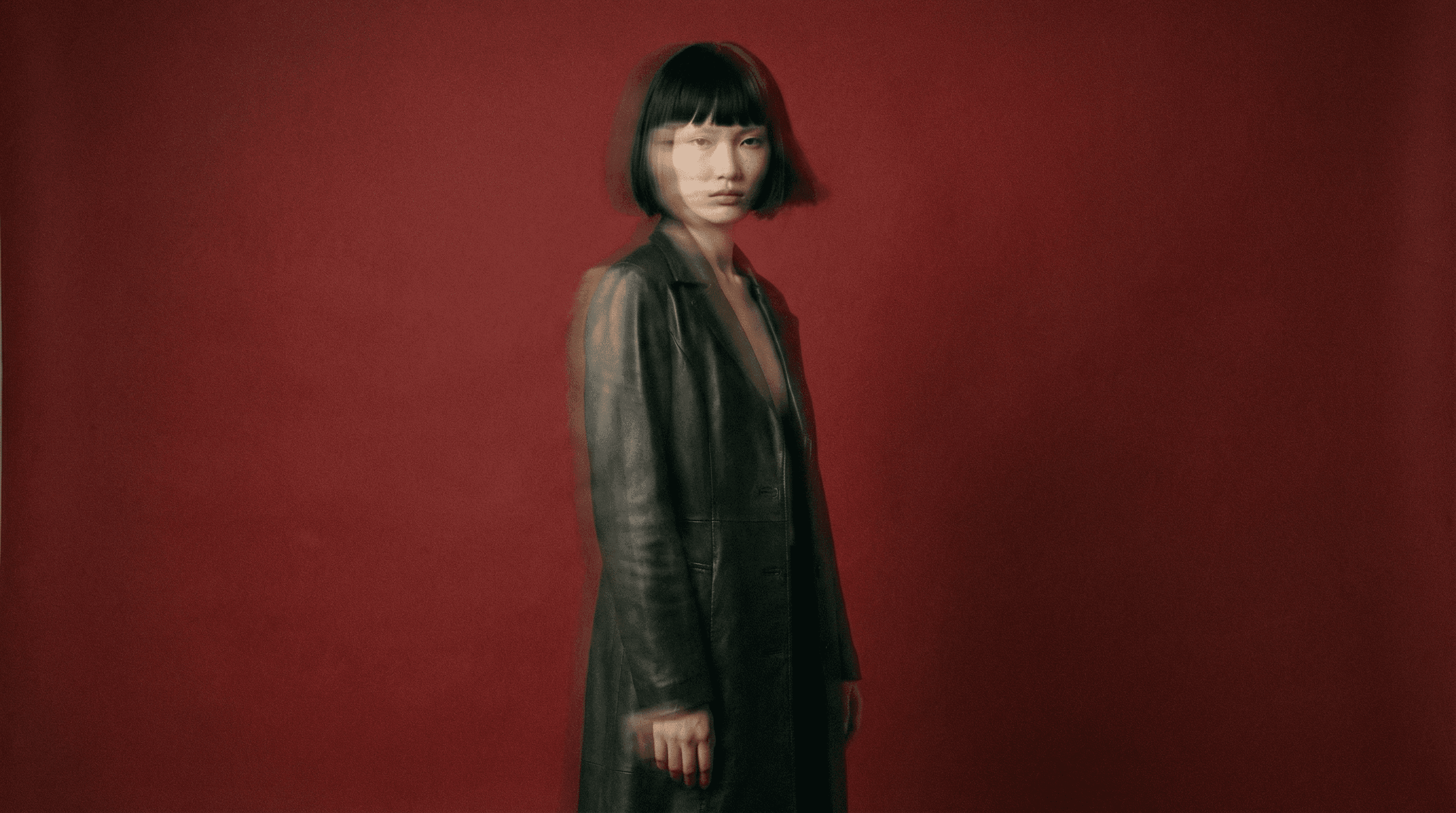 Woman in front of a red background