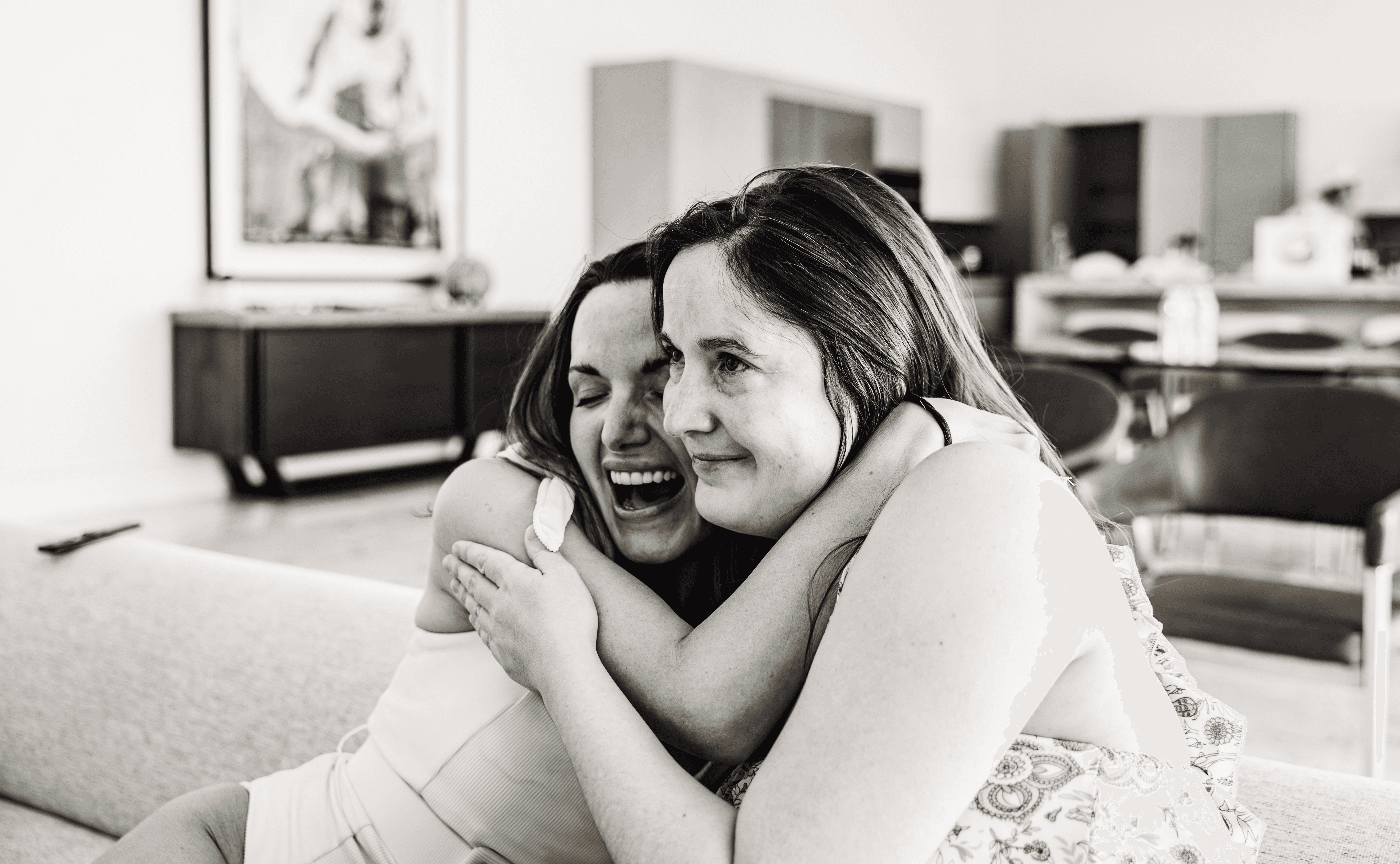 Sisters wrapped in a warm embrace during a sun-soaked bachelorette vacation weekend in Palm Springs — candid, joyful destination bachelorette photography by Lizz Spano Photography, Palm Springs vacation and destination photographer.