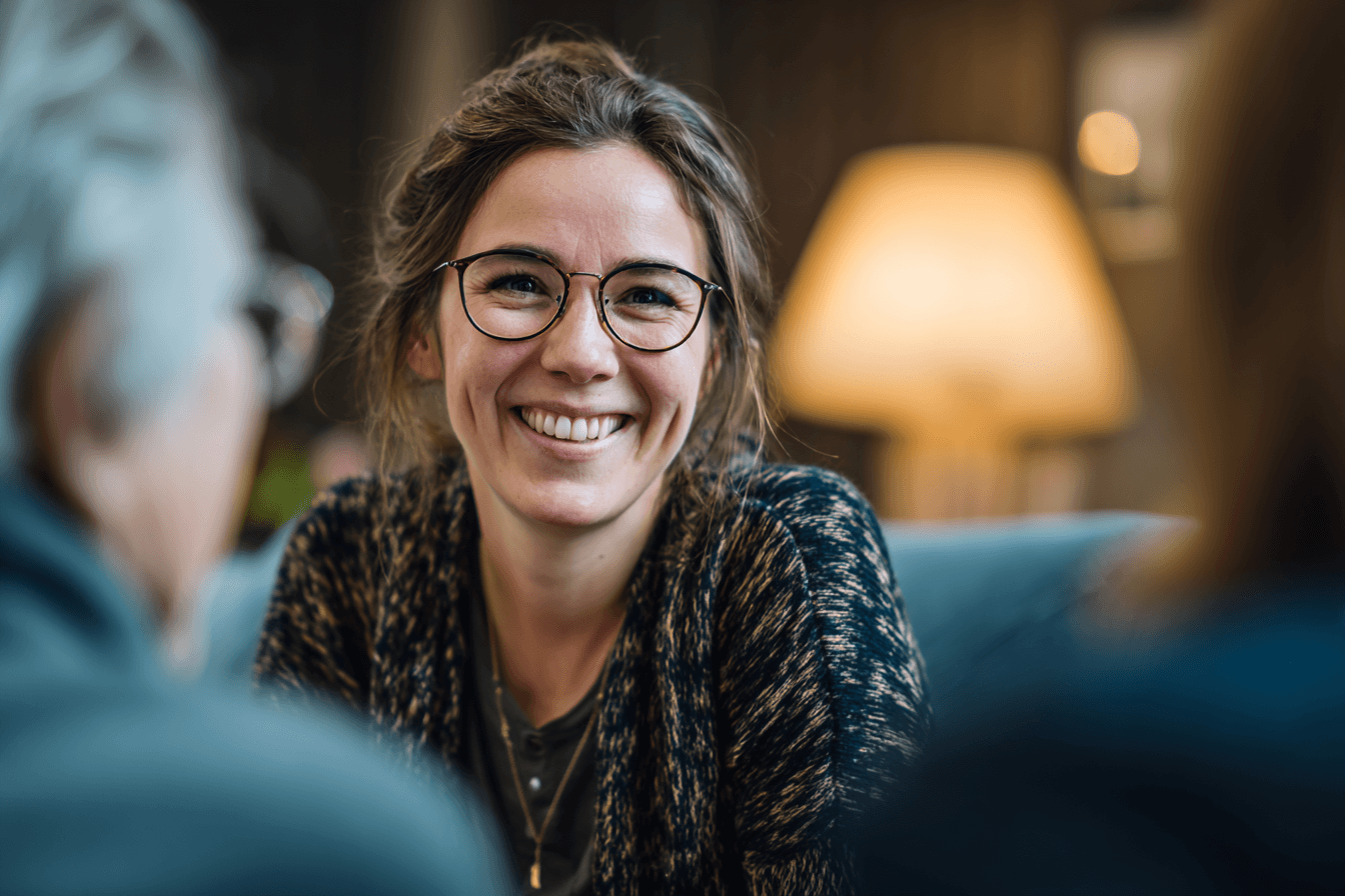 a care manager, chatting with a family, listening and smiling