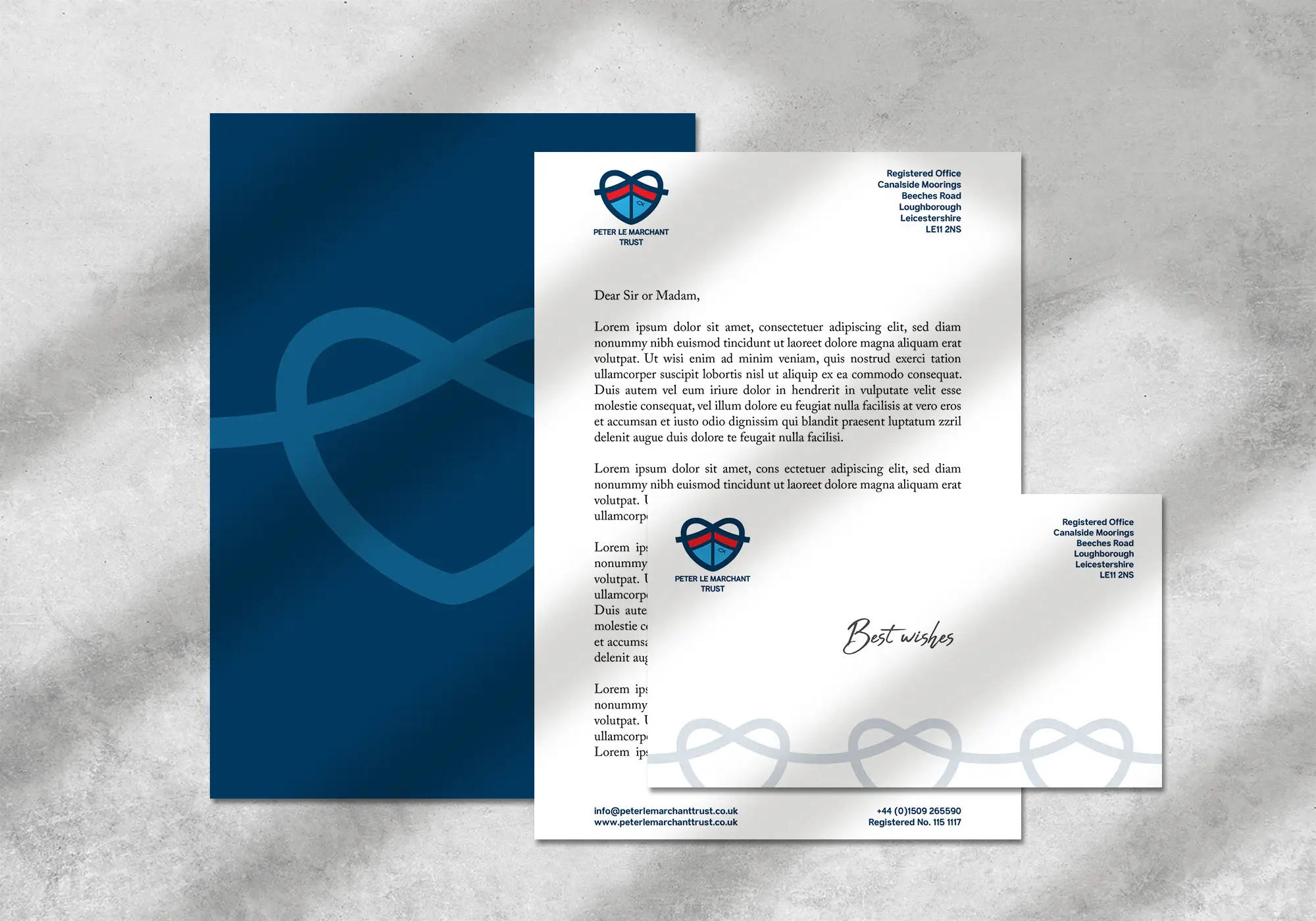 A closed brown notebook with a stylized logo on the cover, placed on a wooden surface against a plain background.