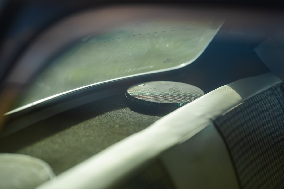 Abstract close-up of smooth, curved surfaces with varying textures and shades of light and dark colors.
