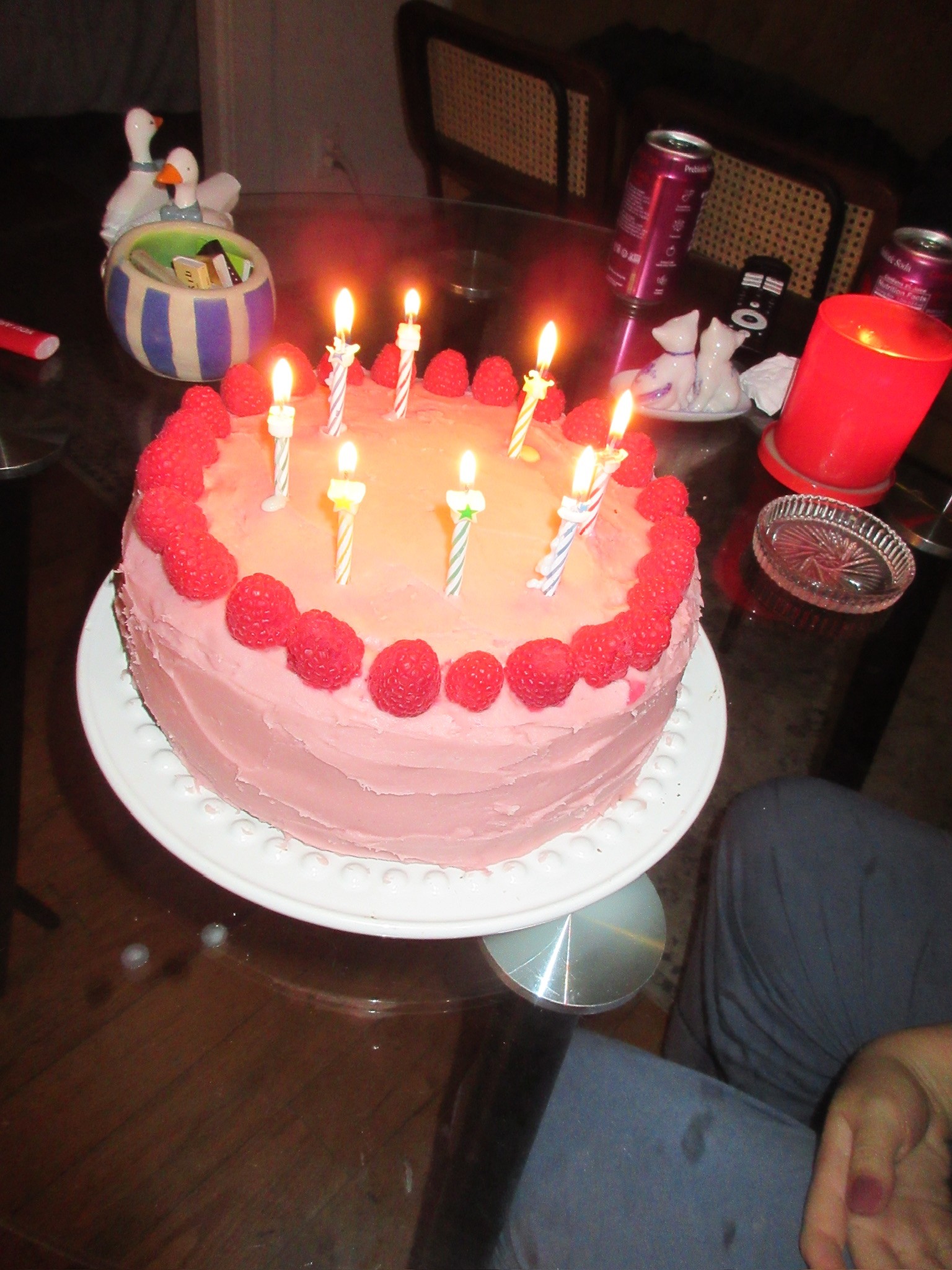 Rasberry chocolate cake with birthday candles on it