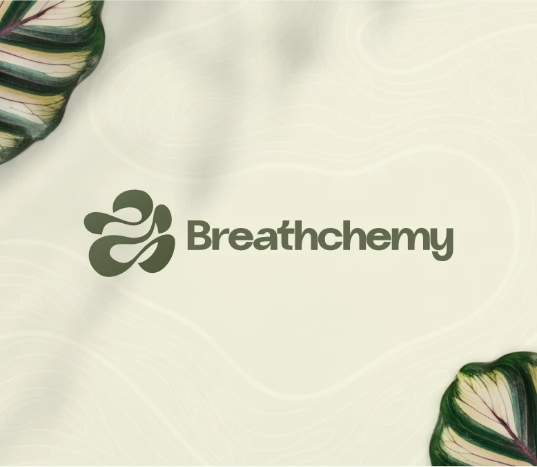 Professional logo for "Breathchemy" in a muted olive green, featuring a minimalist, interlocking icon that represents inner breathing and peace. The logo is centered on a cream background with a subtle topographic texture, framed by organic green leaves in the corners to create a calm, grounded aesthetic.