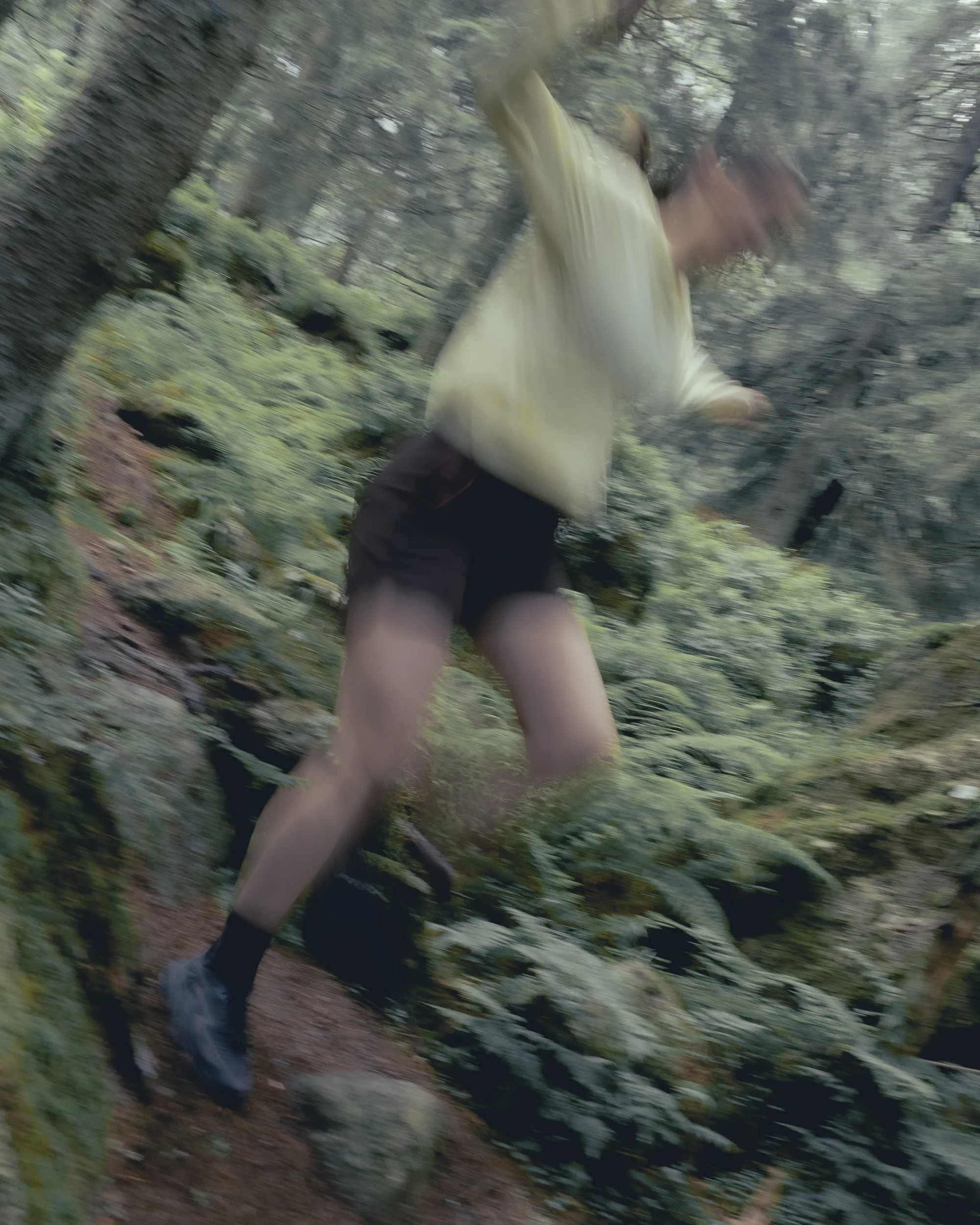 dynamic picture of woman running in the forest.
