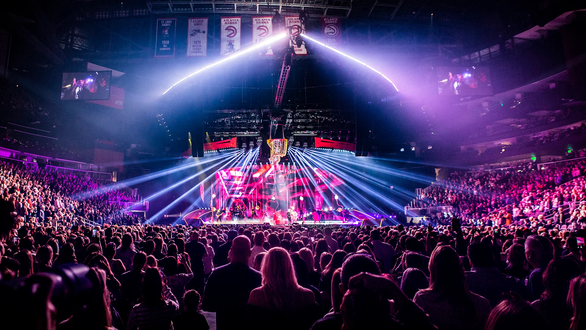 a stage with a laptop and microphone in front of a crowd