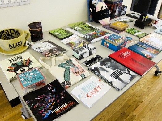 a table full of booklets and flyers and miscellaneous merchandise