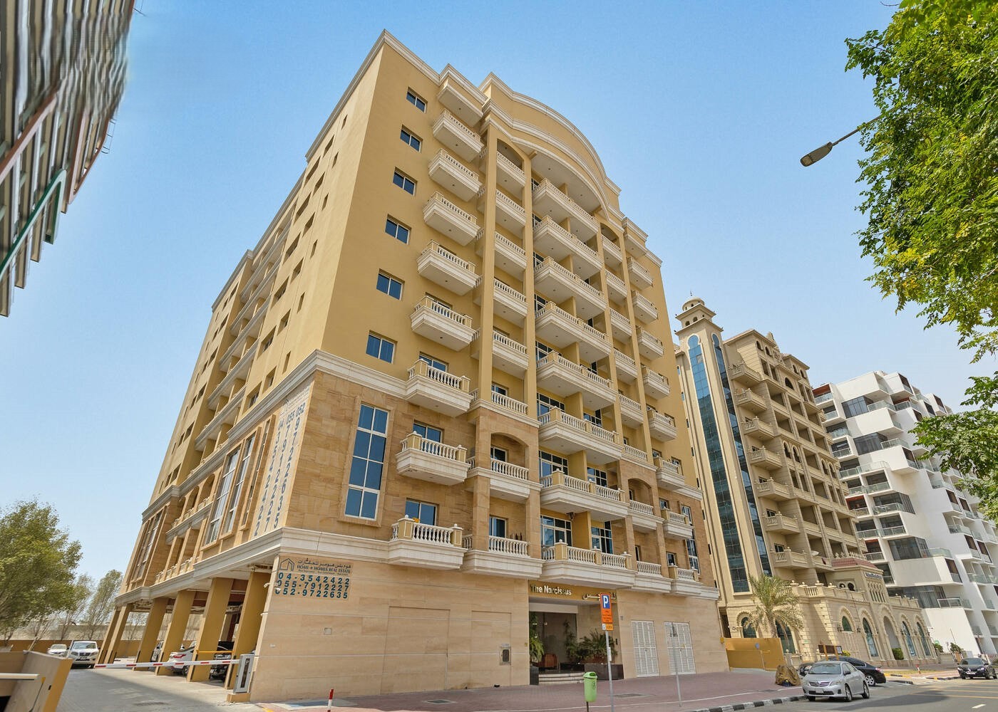 Wide angle shot of a modern apartment complex. Real estate agent listing.