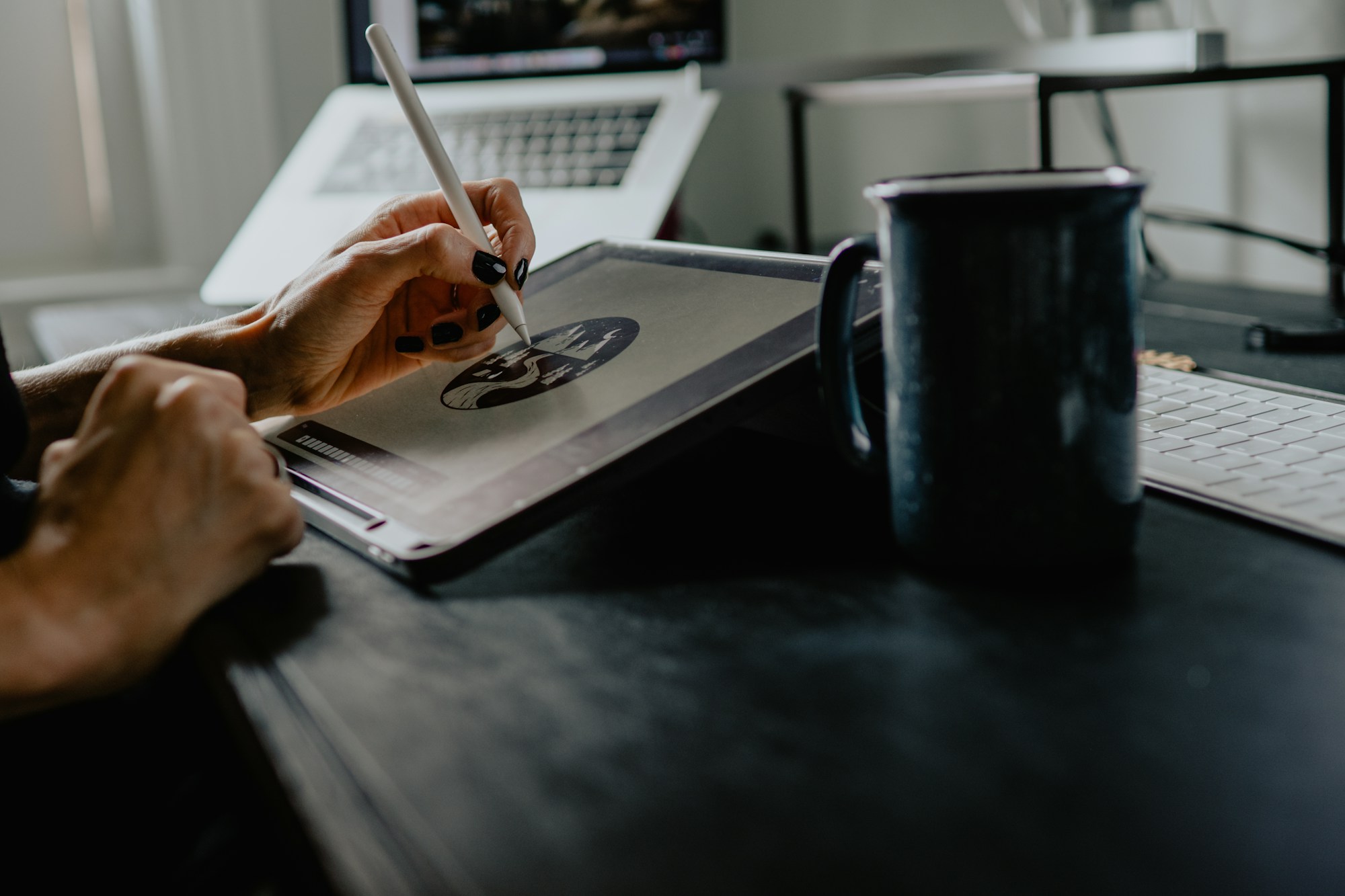 Designer sketching website wireframes at a desk