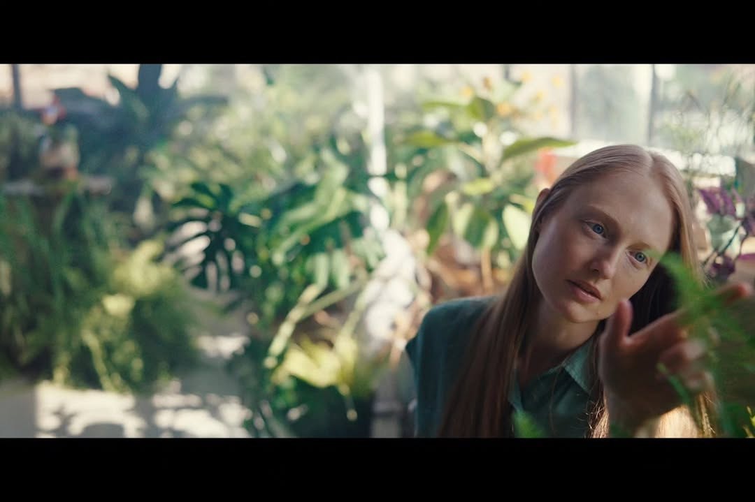 Flora Piper surrounded by dense greenery in Bloom