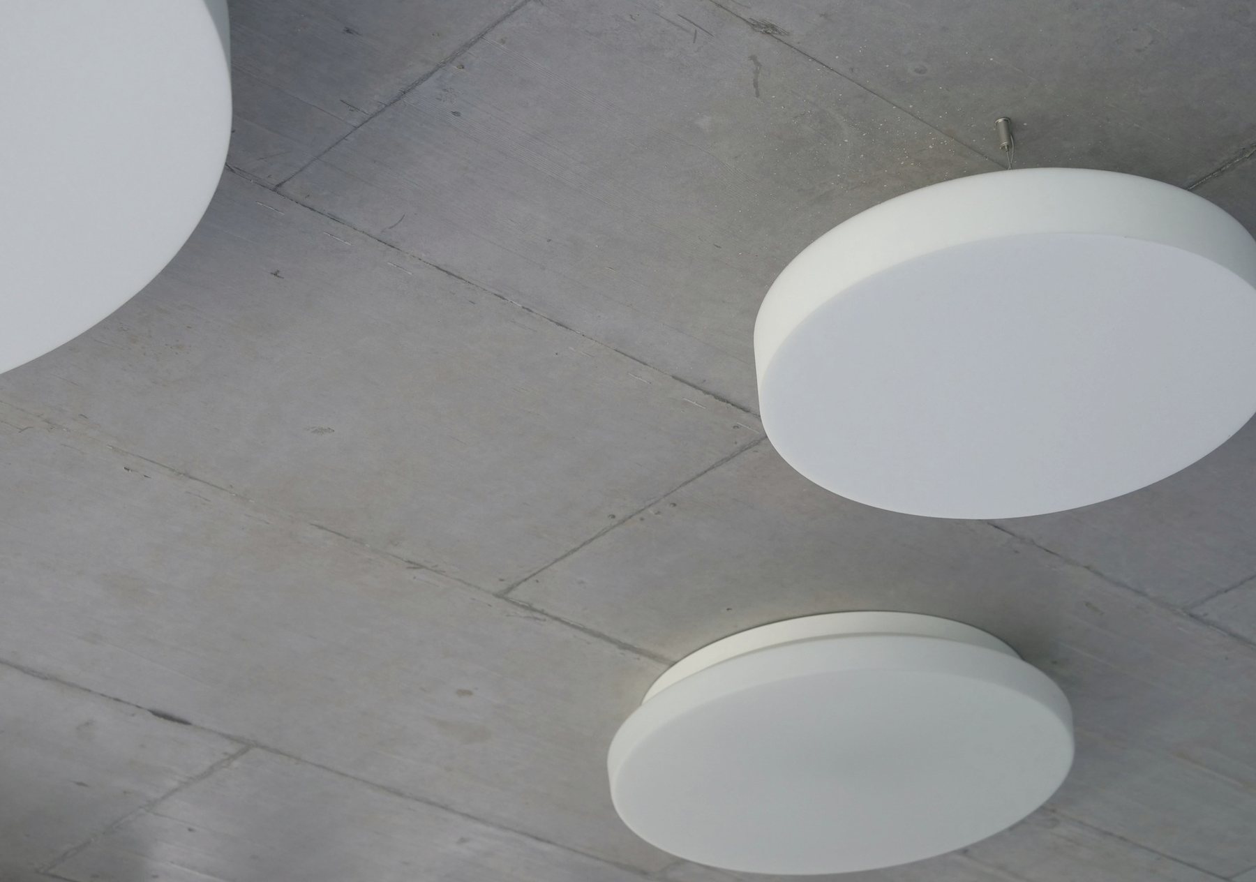 Two wireless access points on a concrete ceiling