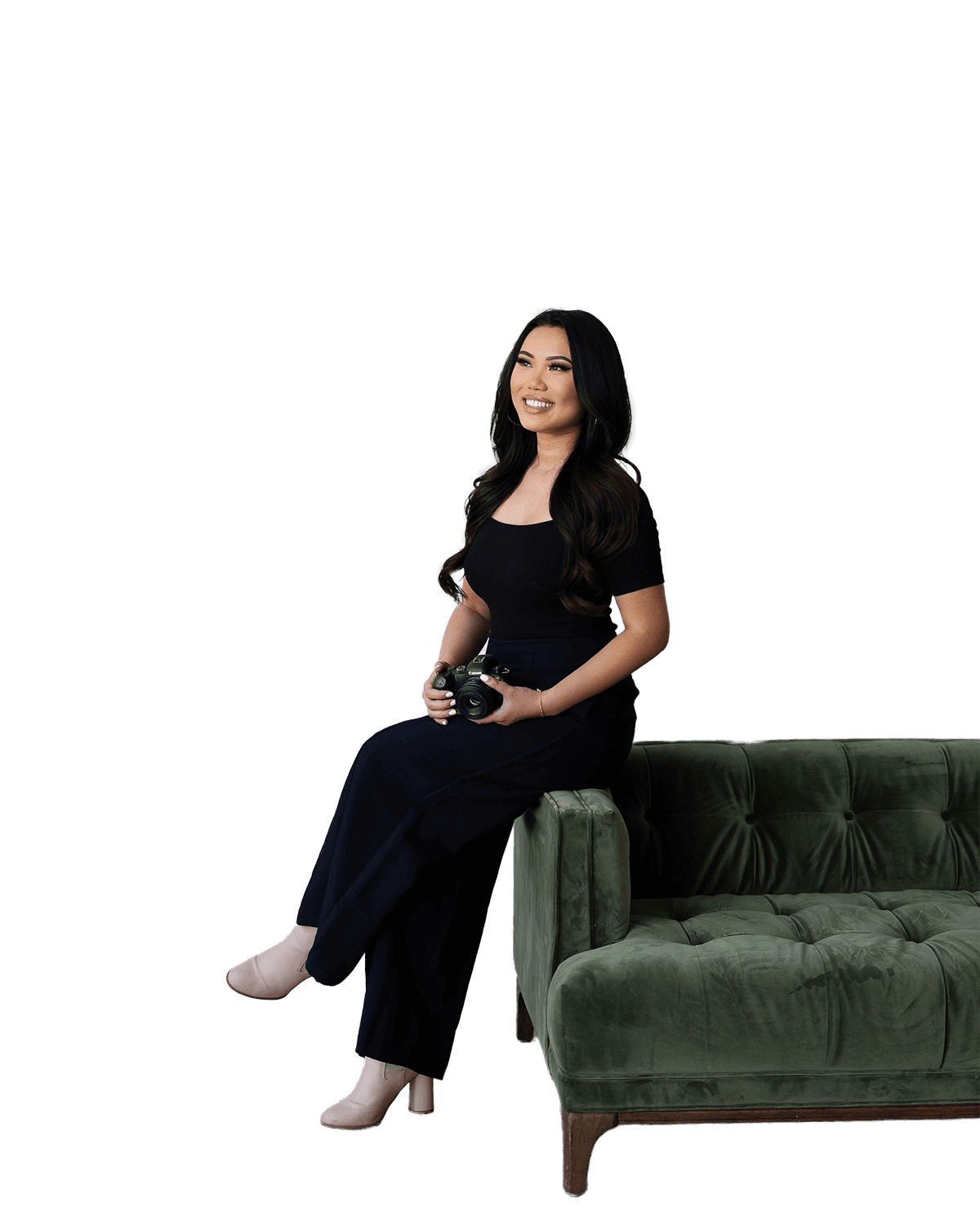 Transparent image of a woman sitting on top of a deep emerald green couch.