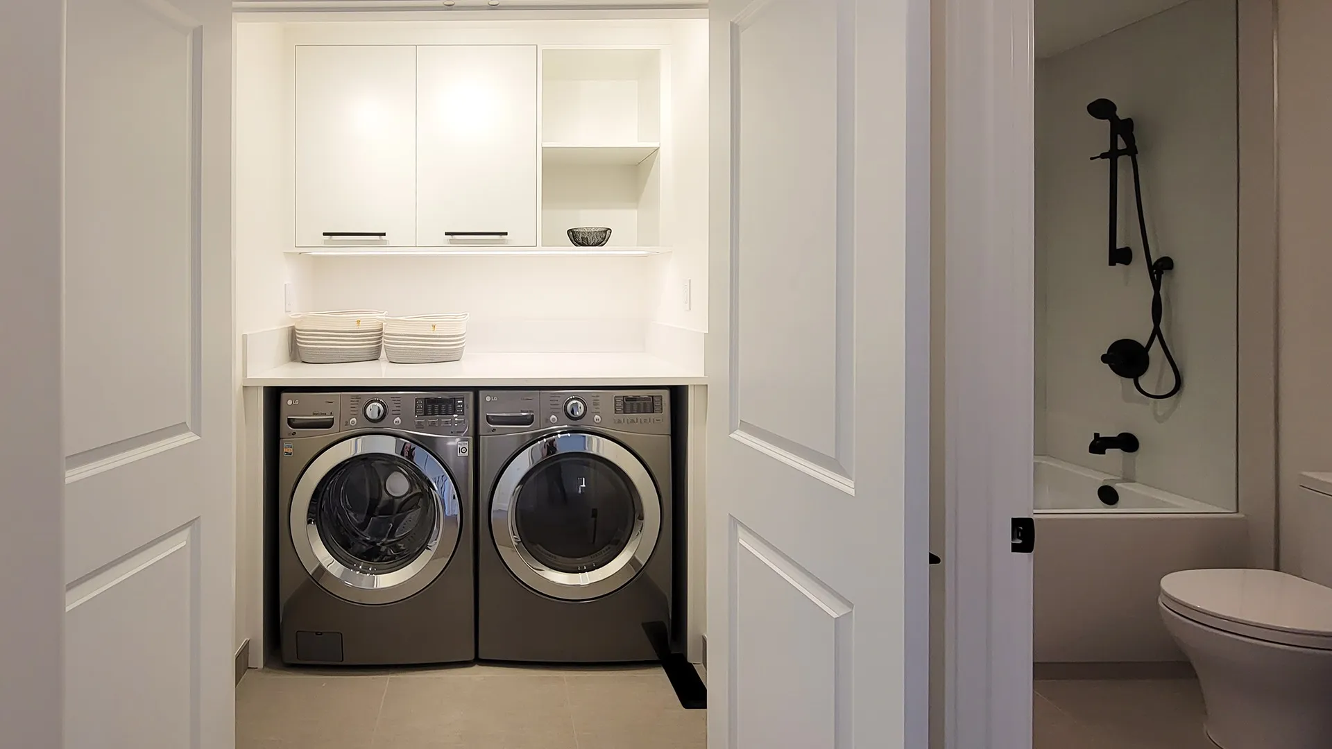 Image of laundry room closet with countertop and upper millwork for loads of storage.