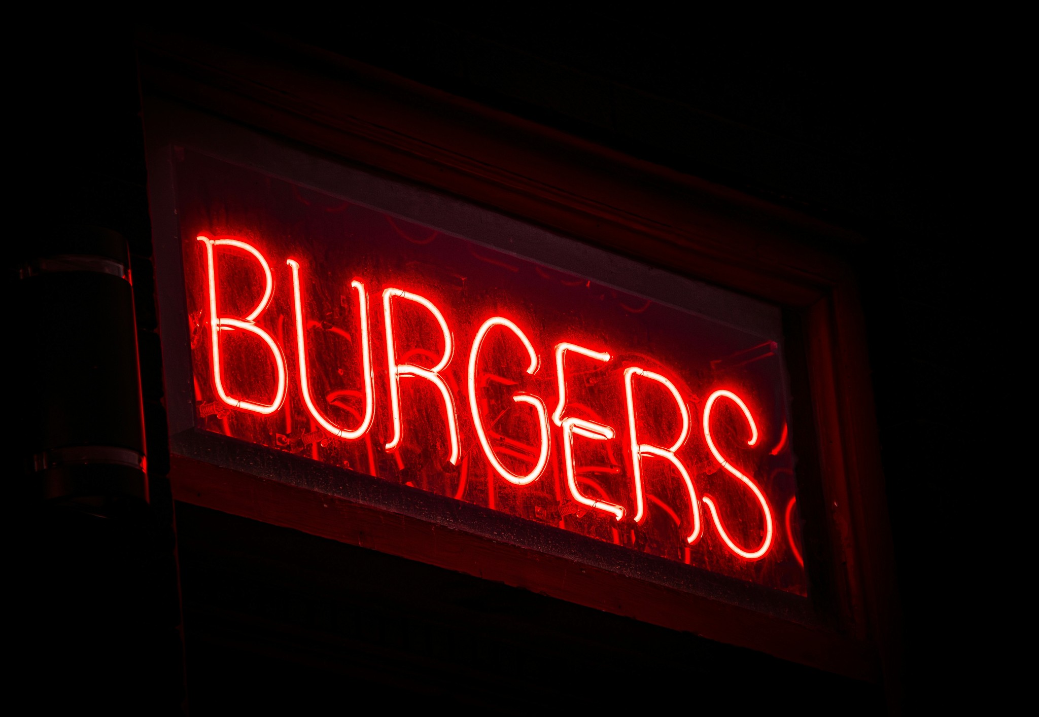 a neon sign that says burgers on it