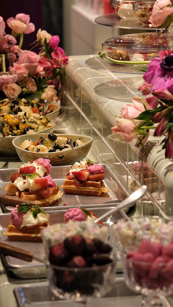 Several dishes placed together on a table with flowers