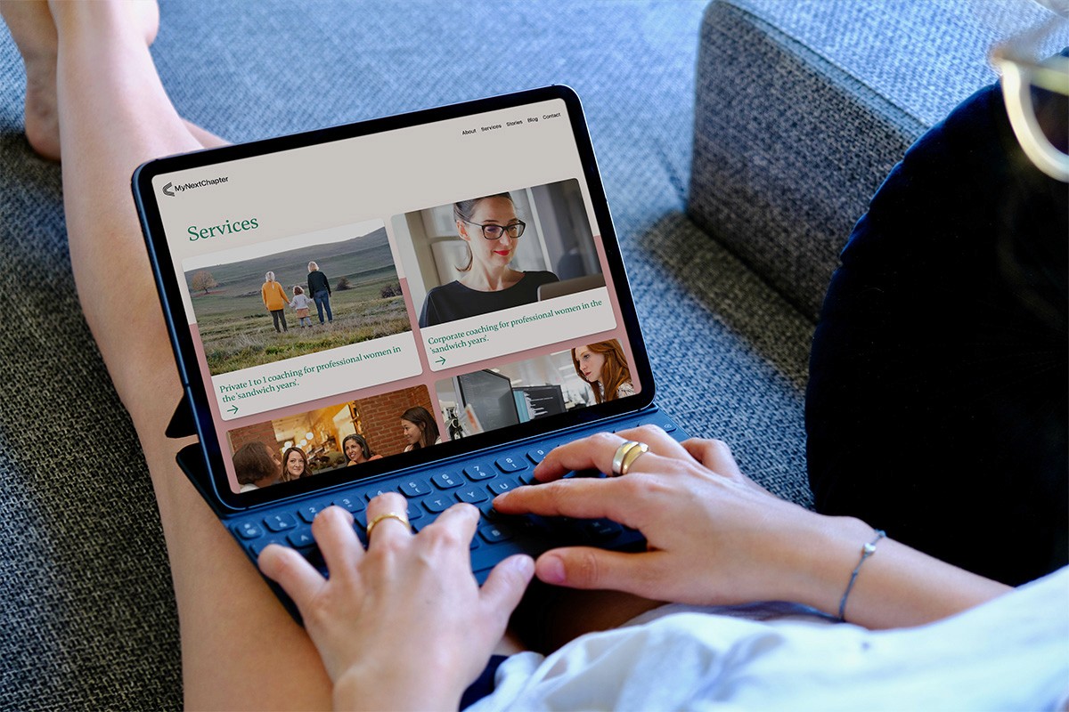 woman at her tablet on sofa viewing the My Next Chapter website