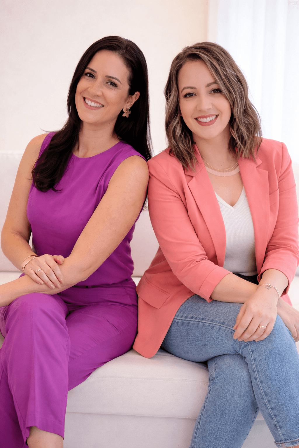 woman sitting while working on laptop and smiling 
