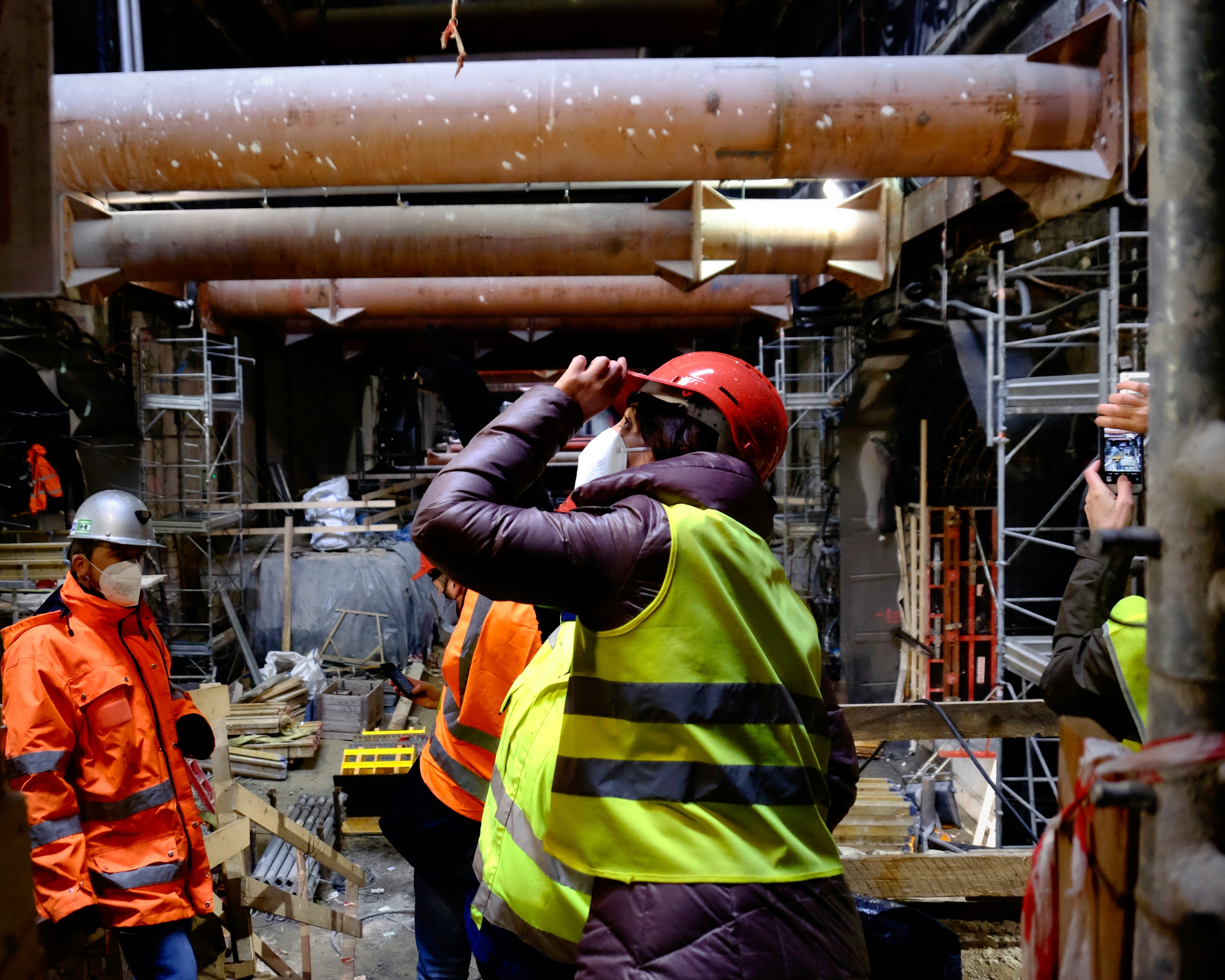 man in black and green striped long sleeve shirt wearing red hat