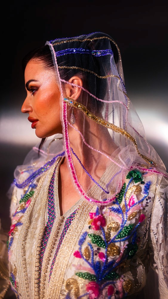 Ivory Moroccan caftan with colorful floral embroidery, handcrafted luxury piece for elegant events in Bahrain