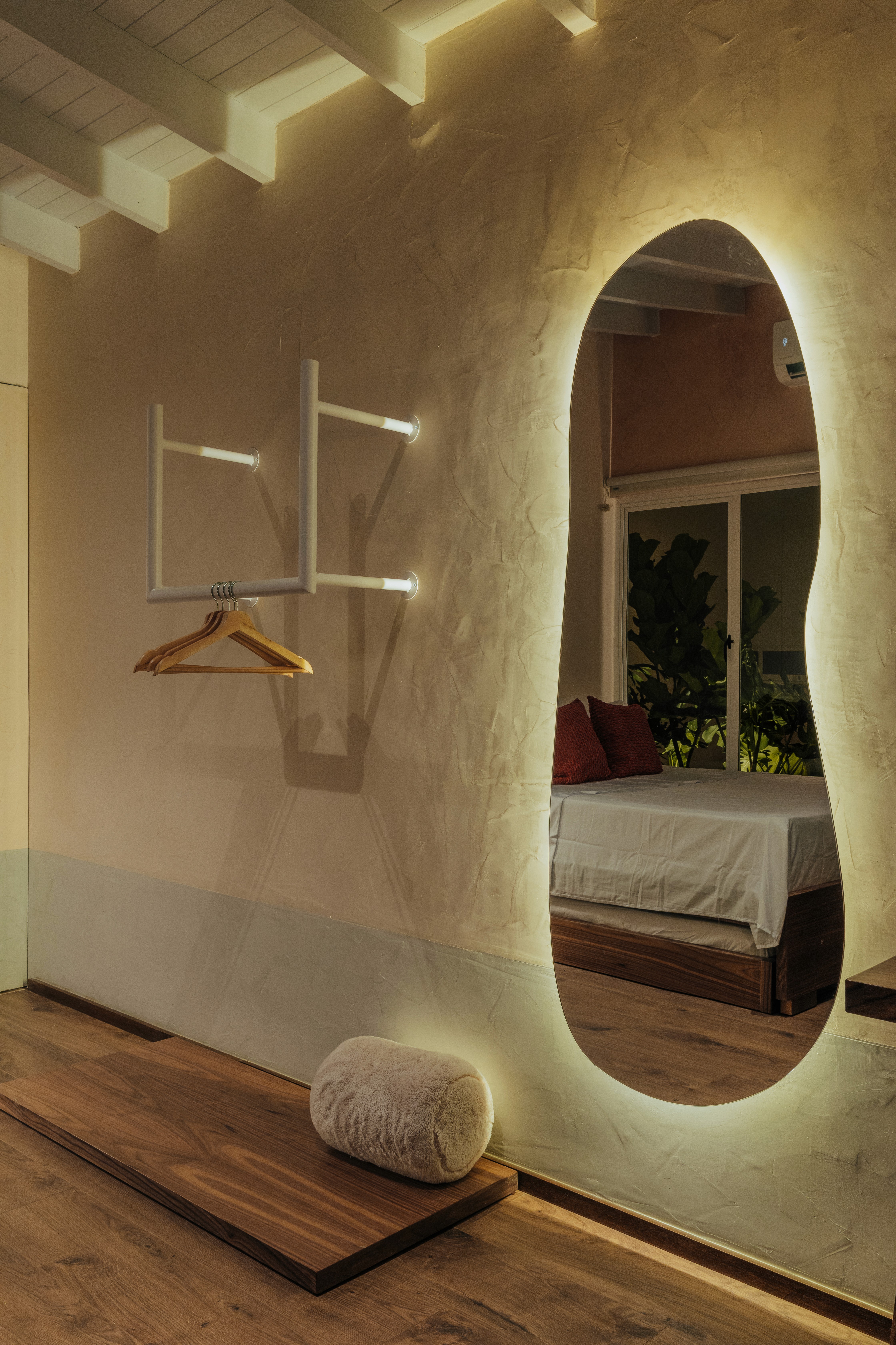 Double-height interior with flowing sculptural forms and warm raking light