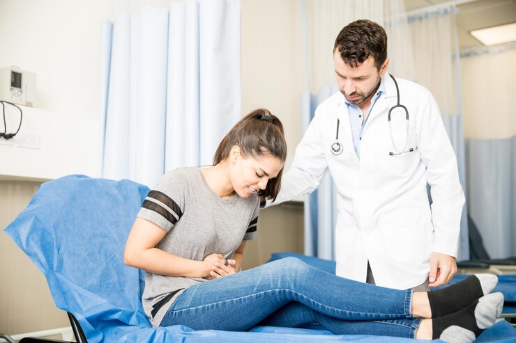 A women facing some stomach aches and the dosctor is helping her out.