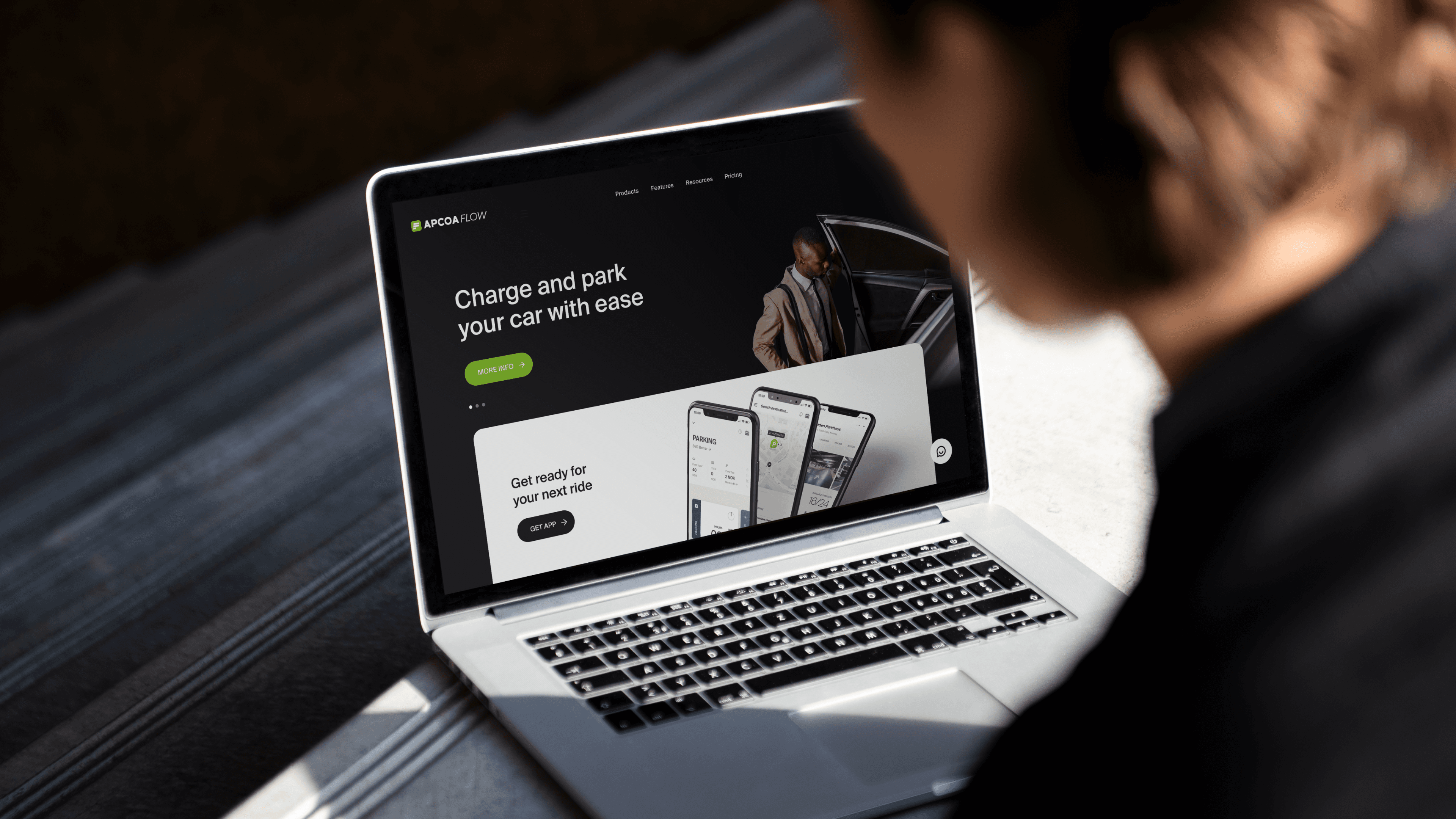 A laptop mockup displaying the APCOA Flow marketing website and value proposition.