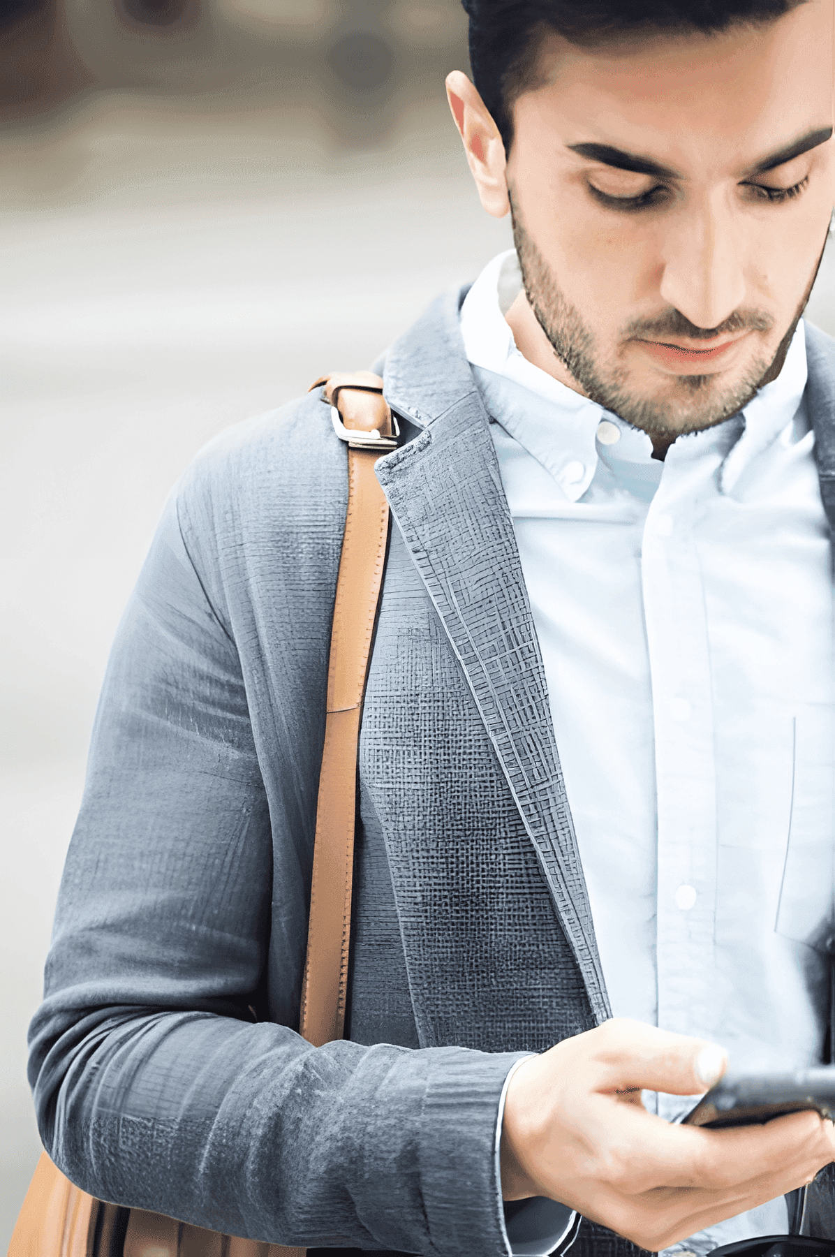 Close-up of a dark green leaf showing its textured surface and central vein against a muted background.