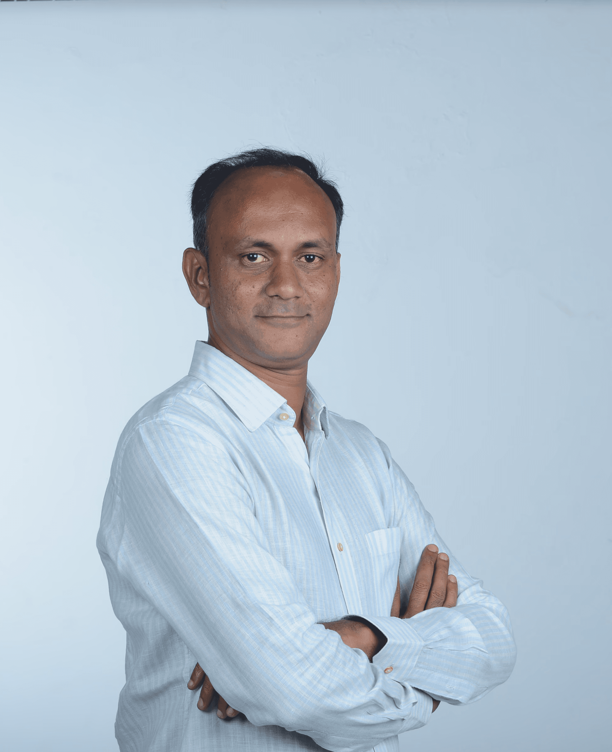 Profile portrait of a man in a white shirt against a light background