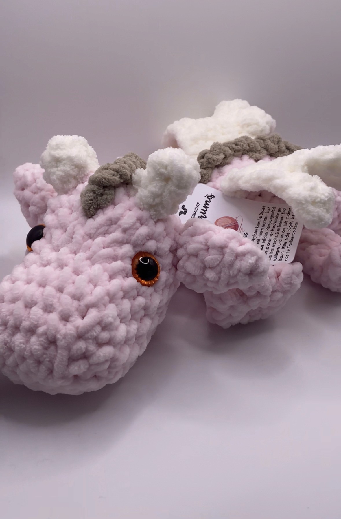 A crochet pink bunny peeks through the table.