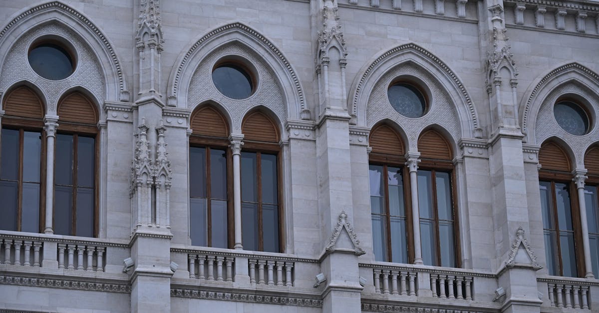 Close-up of gothic style windows in an ornate historic building facade.